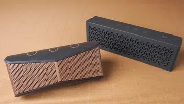 The wedge-shaped Logitech X300 and the more traditionally shaped Creative MuVo Mini.