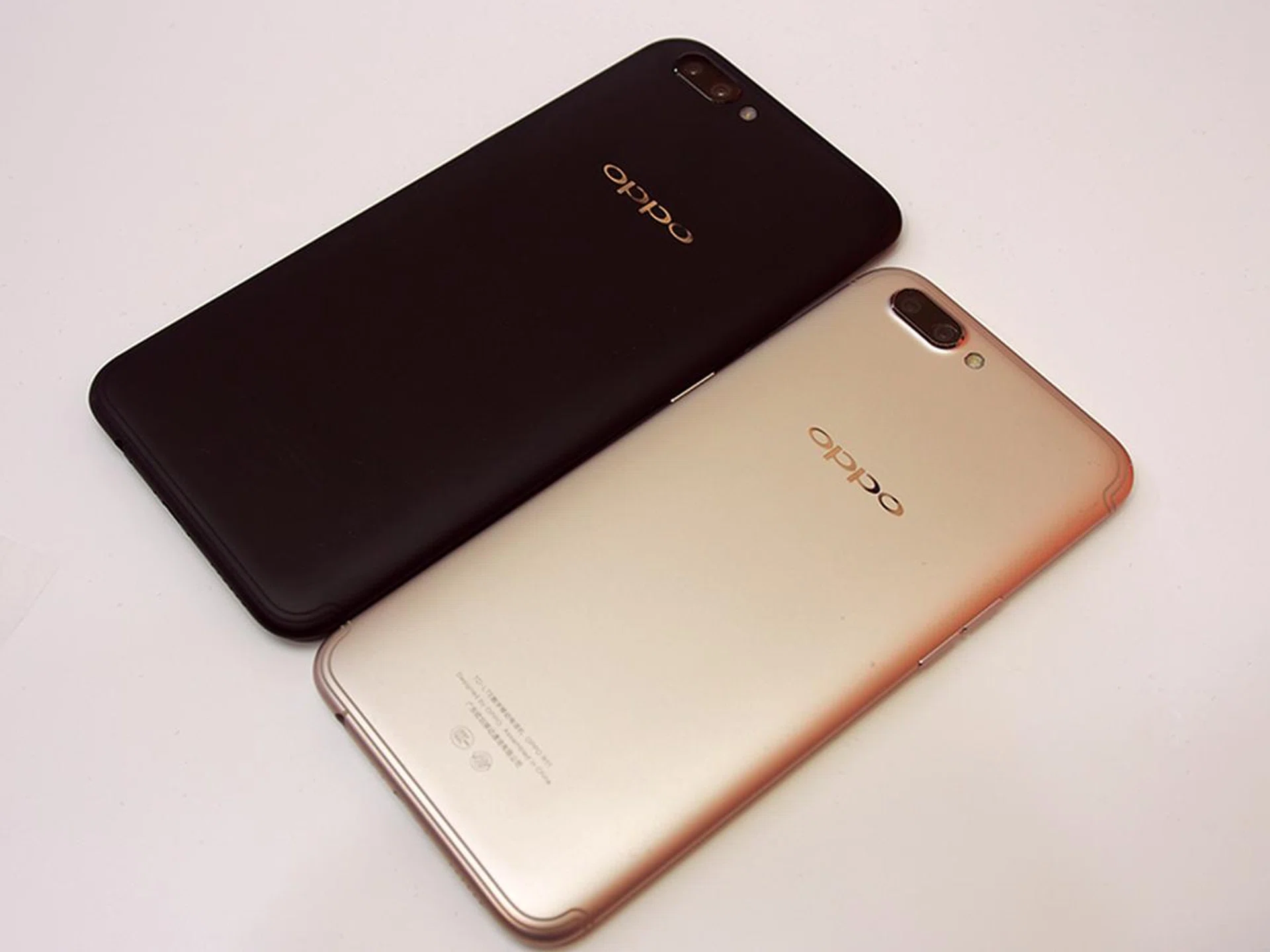 Oppo R11 Plus (Black) next to the regular R11 (Gold).