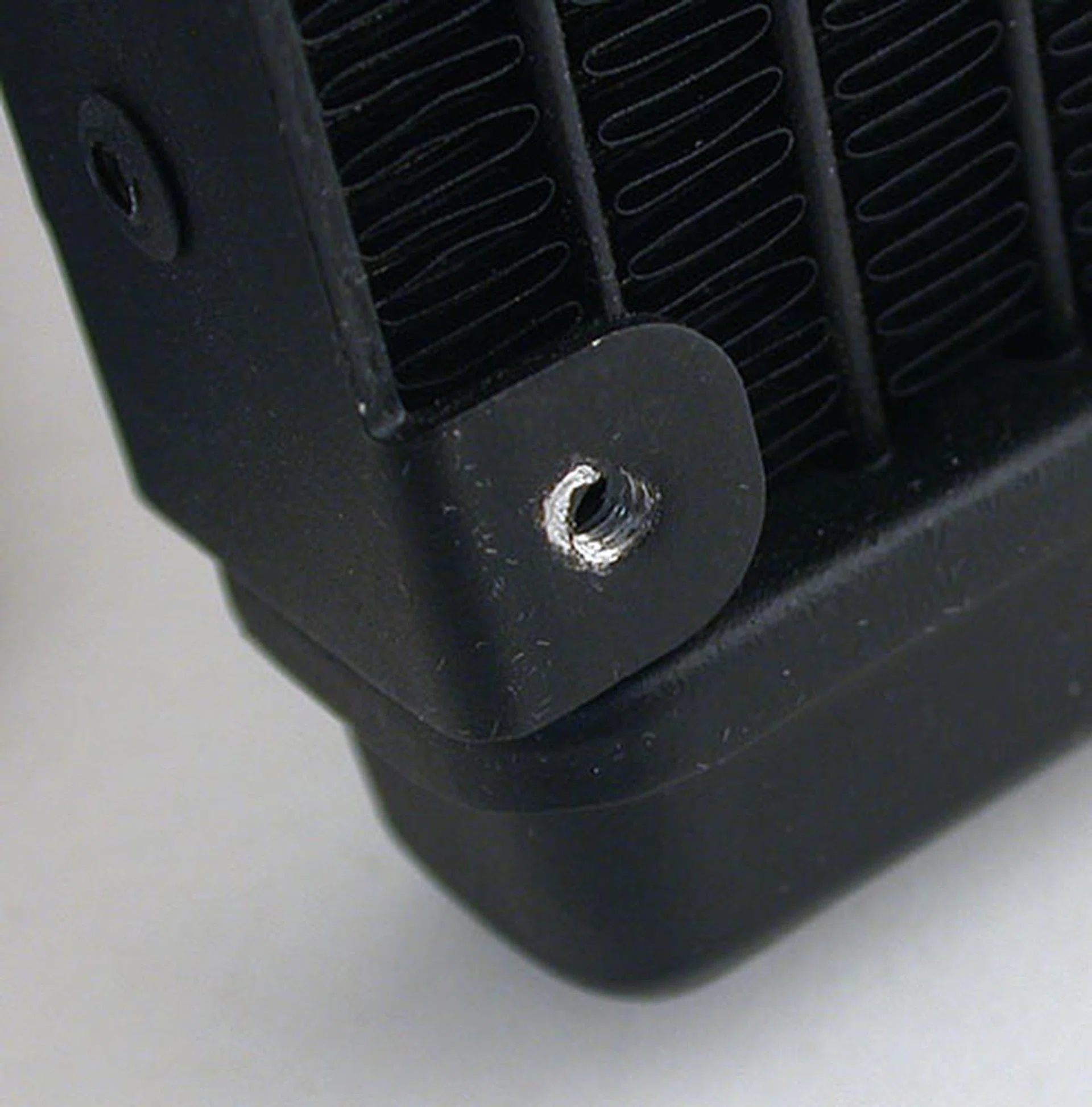 The screw holes on the radiator showing signs of abuse as we were literally in the dark, trying to find the right screw holes with trial and error. 