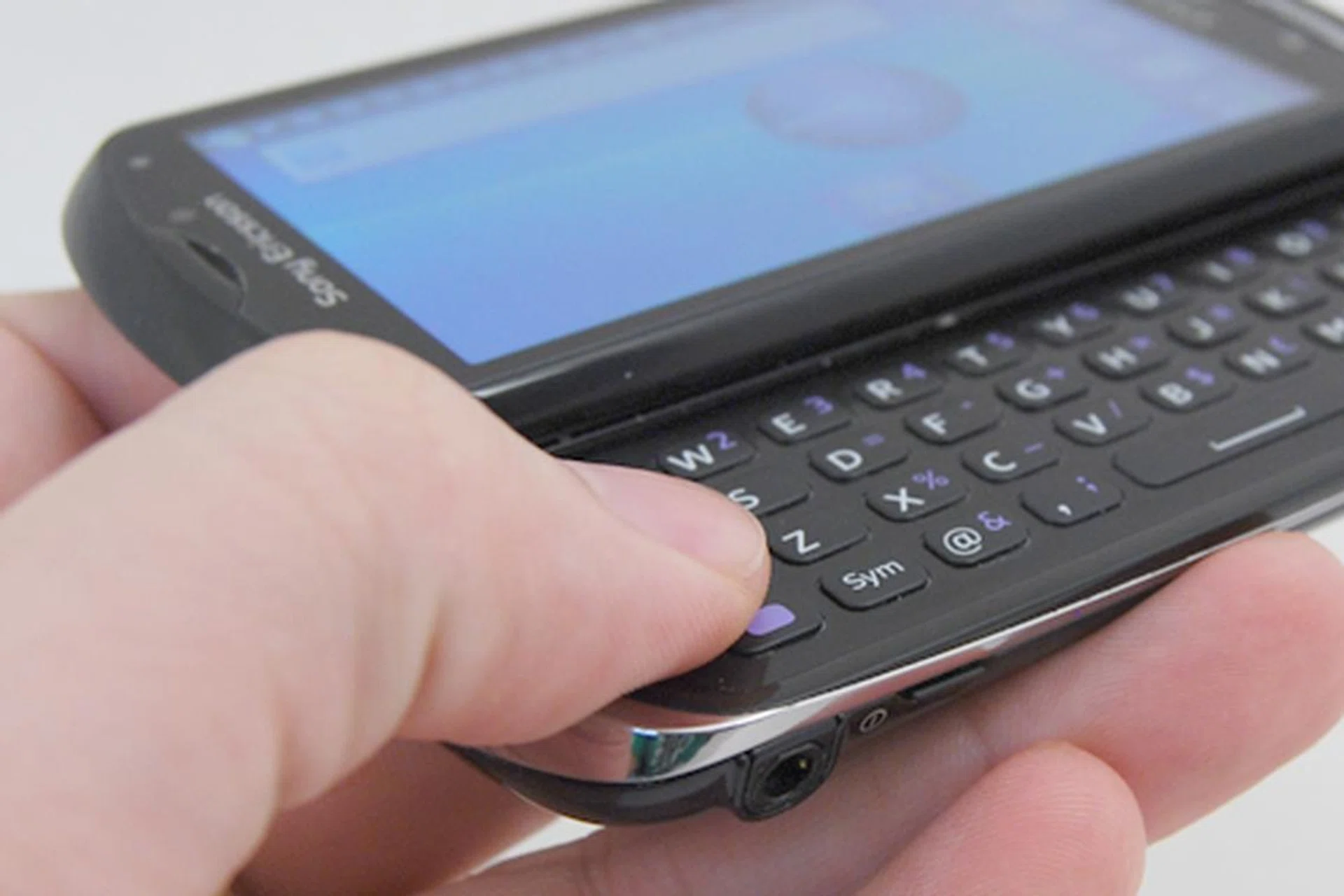 The physical QWERTY keyboard creates more screen real estate, but the downside is that it's stiff and thus slows down typing (slightly).
