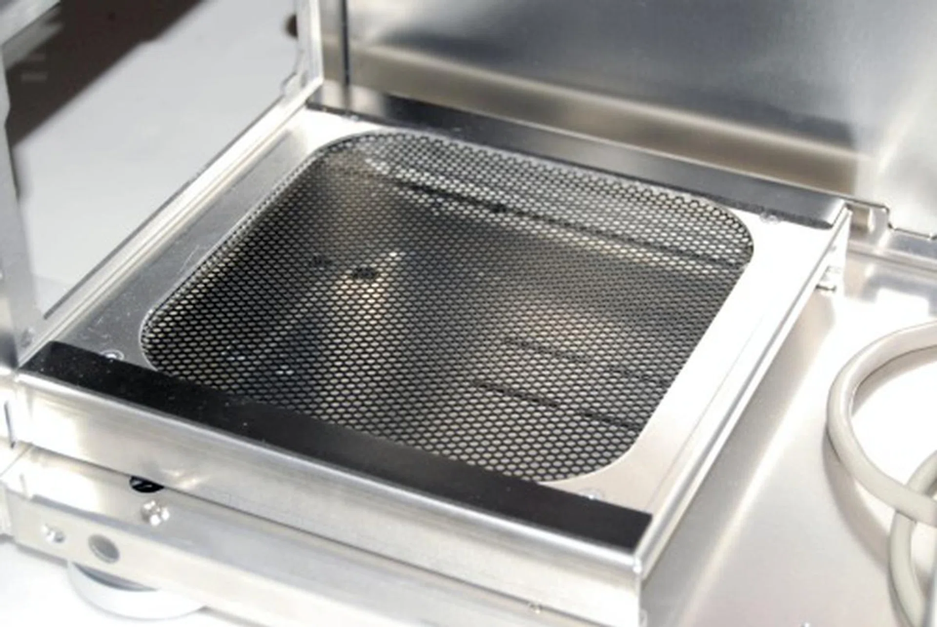 Here's the PSU bay up close. The two black strips are padding for the PSU to rest upon and helps dampen any vibration it might pose.
