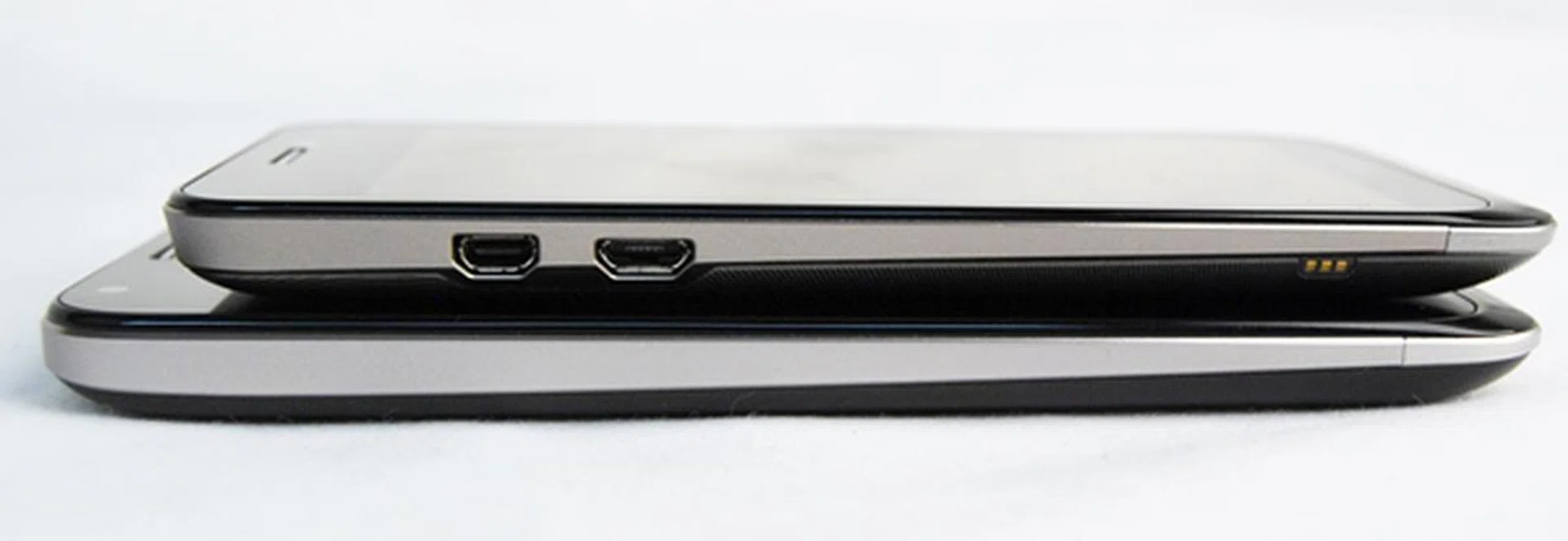 The left side of the ASUS PadFone 2 (bottom) has a cleaner look as the micro-USB and micro-HDMI ports are removed.