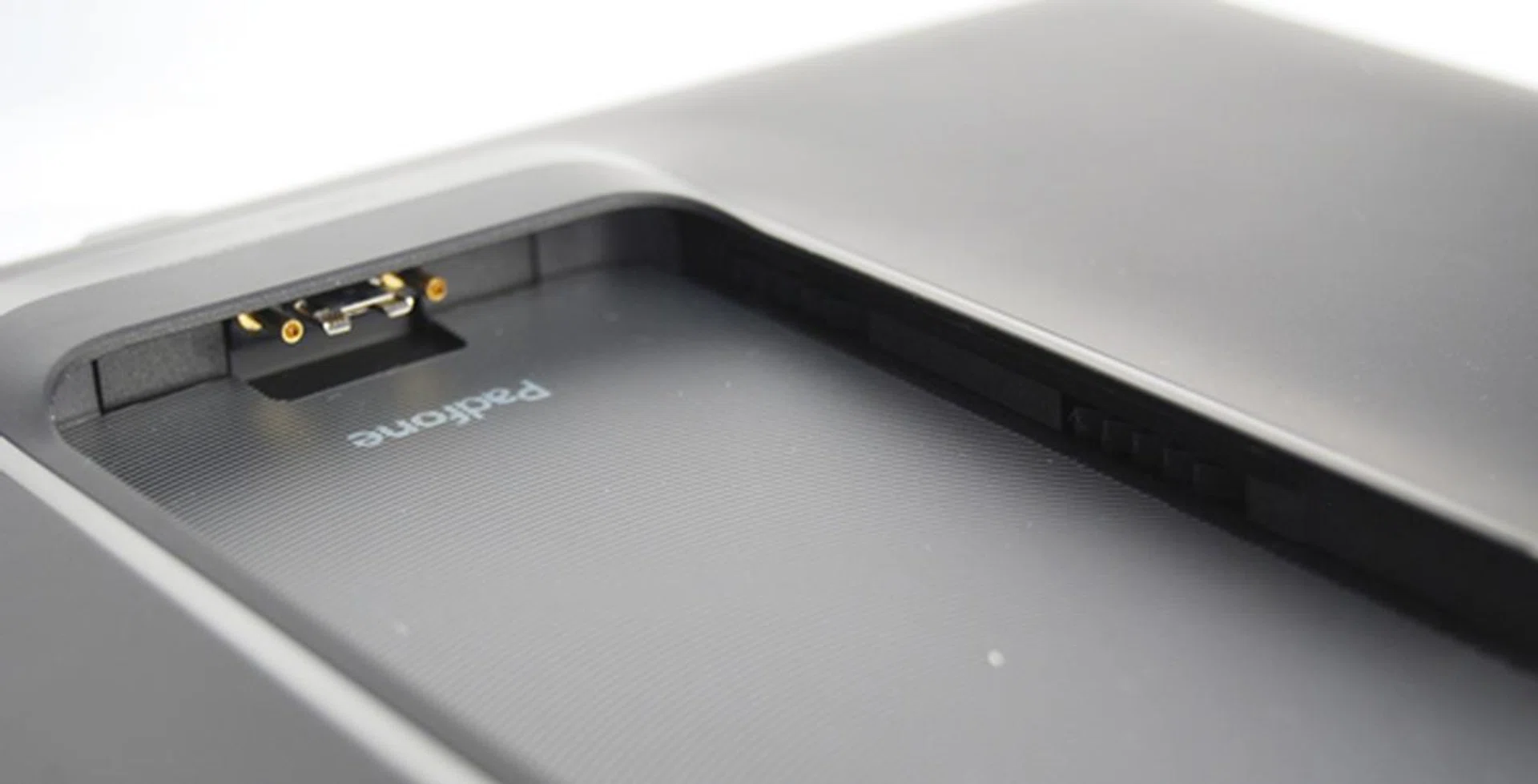 As the new PadFone Station uses a 13-pin MHL connector, it is not possible for you to dock the first-gen PadFone. There are also two rubber pads on each side to secure the PadFone 2 in the dock.