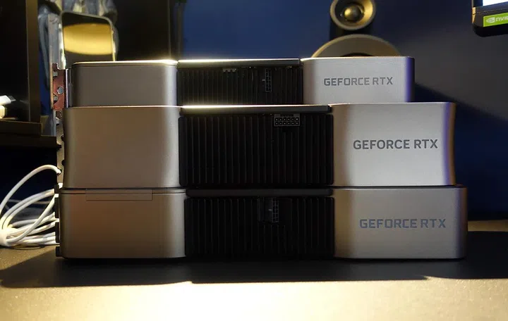 A look at the cards' side profile reveals how much chunkier the RTX 4090 Founders Edition (center) is as compared to the RTX 3090 Founders Edition, and will occupy four expansion slots in your PC.

