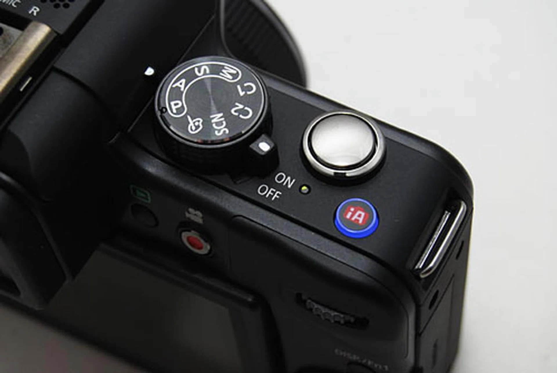 A close-up of the G3 for comparison. The helpful iA button is still there, but the Mode dial has been simplified and the video Record button has been shifted to the back.