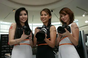 Three lovely models show the A900s off to the media.