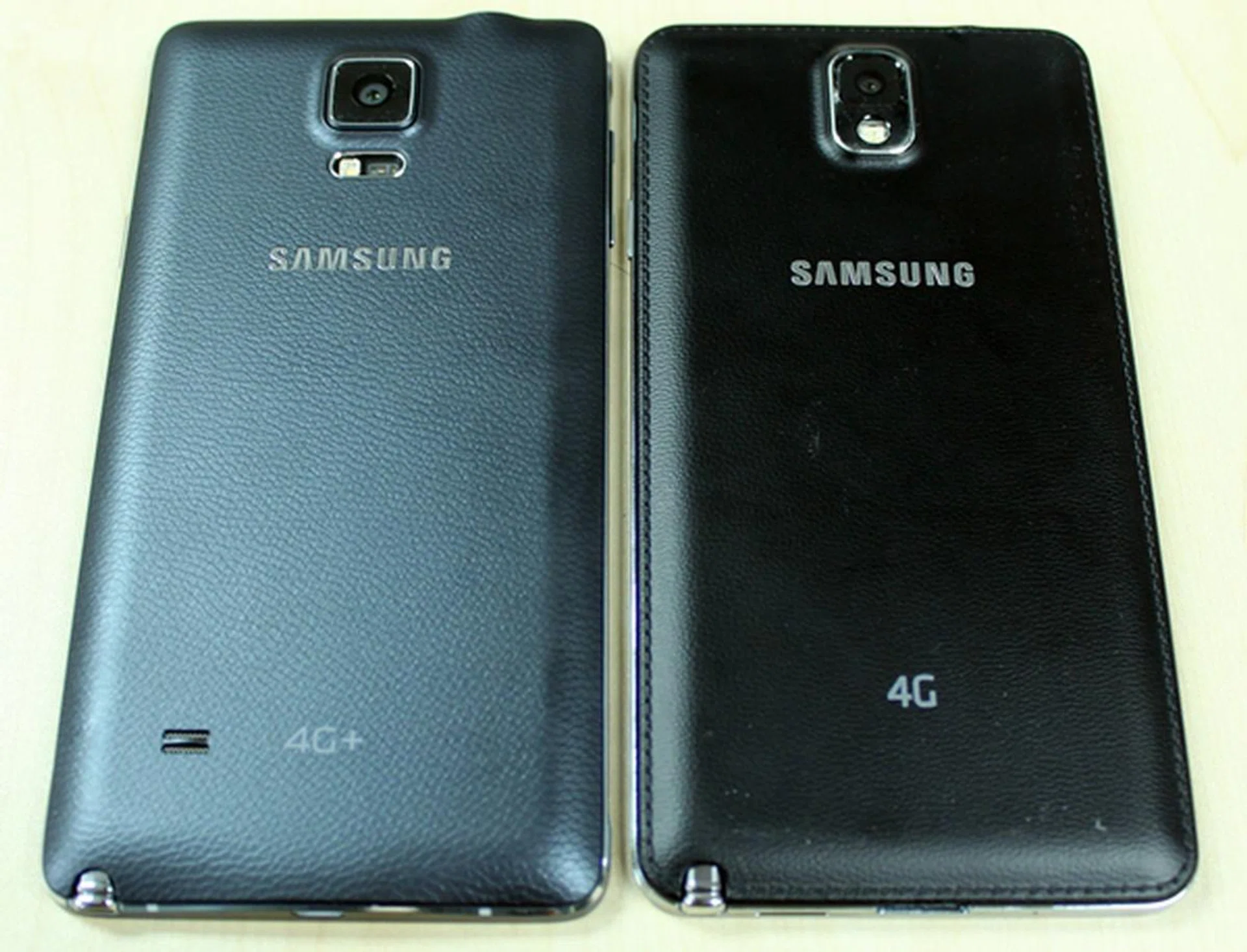 No more leather stitching on the Samsung Galaxy Note 4 (left).