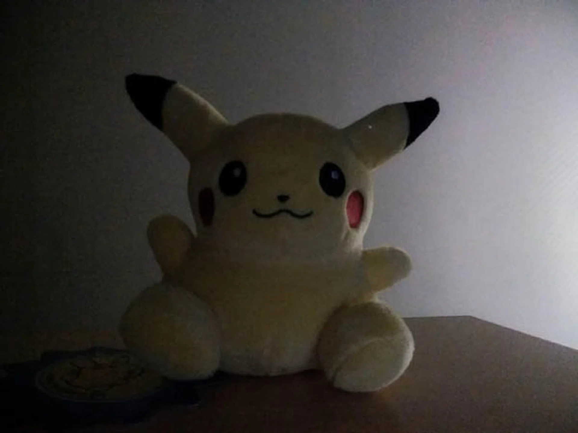 Pikachu taking selca under low light.