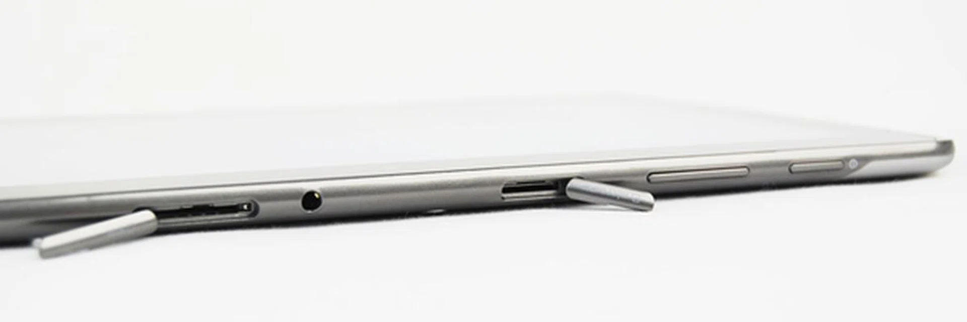 Both the SIM card (left) and microSD (right) card slots are covered with plastic lids to protect the internals from external elements.