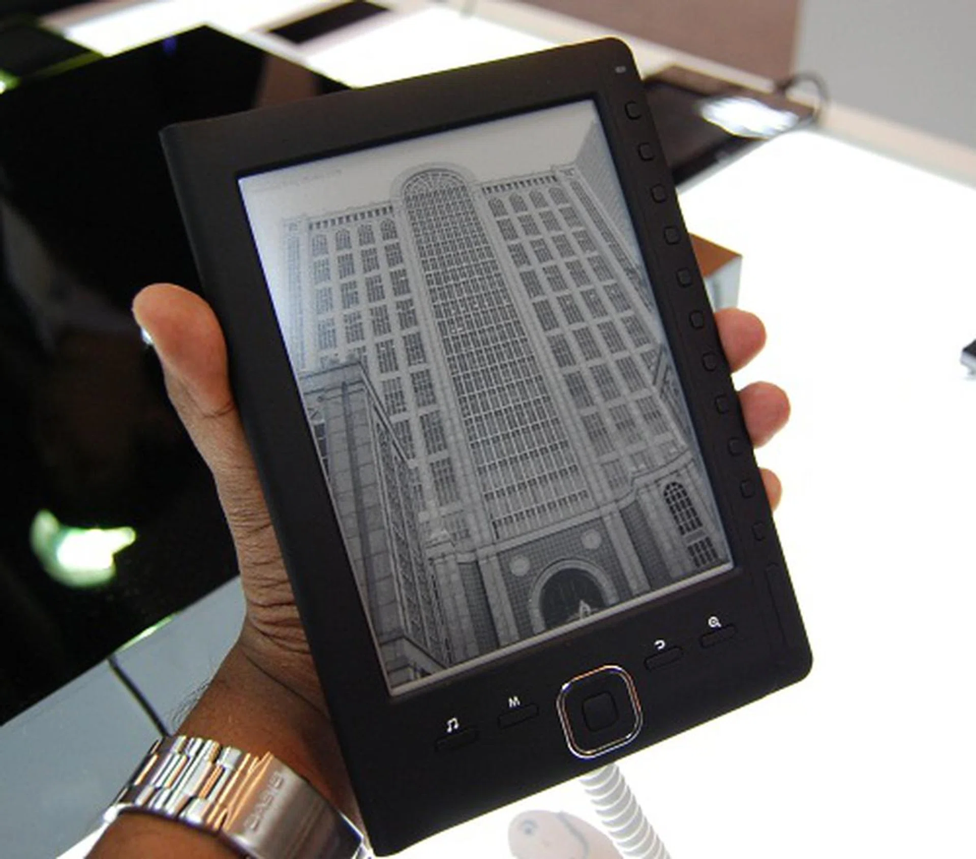This is the BK6001, which uses an ARM processor and has a 6-inch E Ink display (8 greyscale levels). It supports microSD card for external storage and a variety of ebook and multimedia formats like PDF, ePUB and even OGG. At around 170g, it's light enough with a battery rated at 20 hours or 4000 pages.