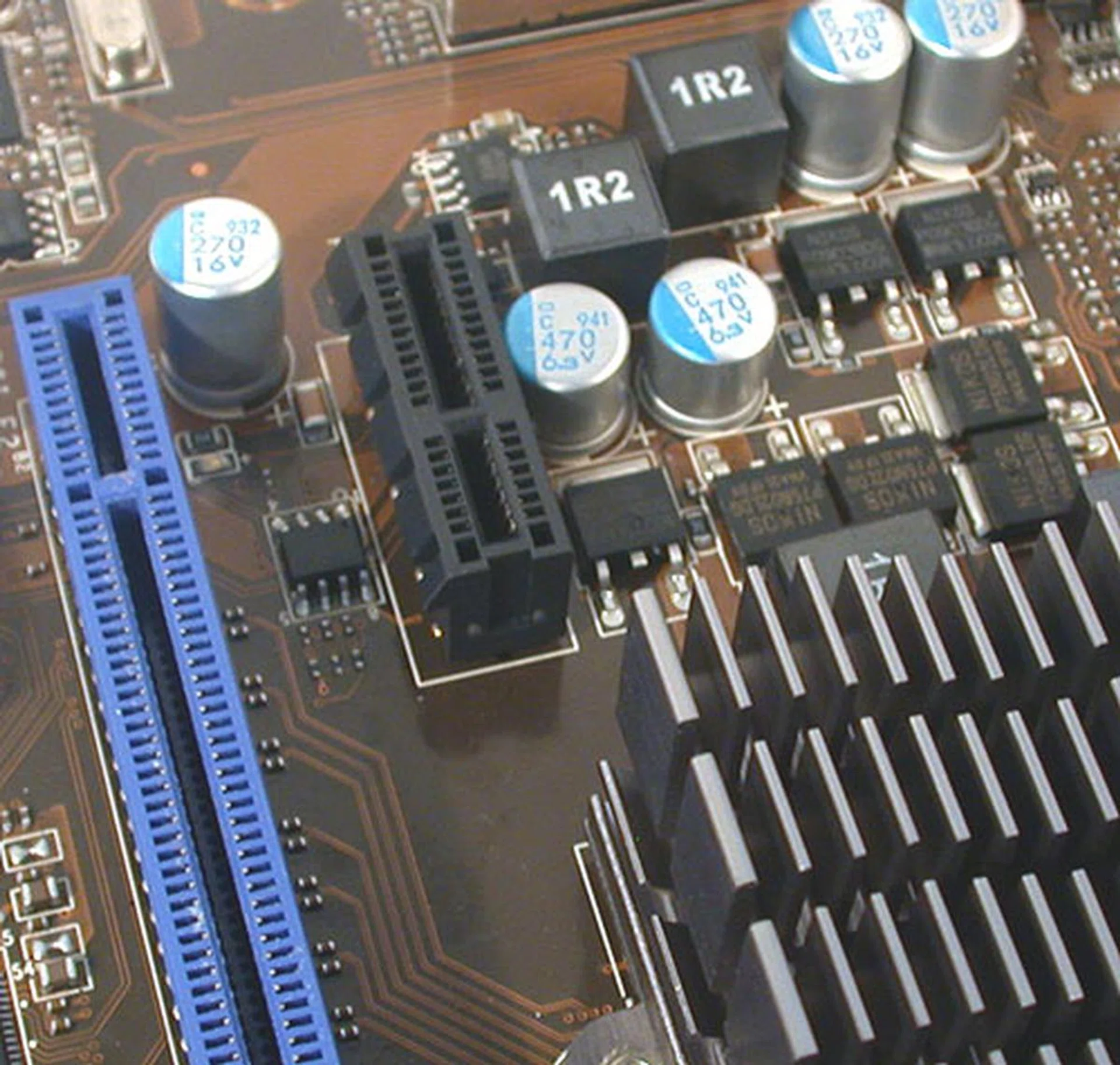 Like we said, it's a crowded board and often, we doubt if some of these slots would actually see any use. For instance, this PCIe x1 slot here is so close to the heatsink. 