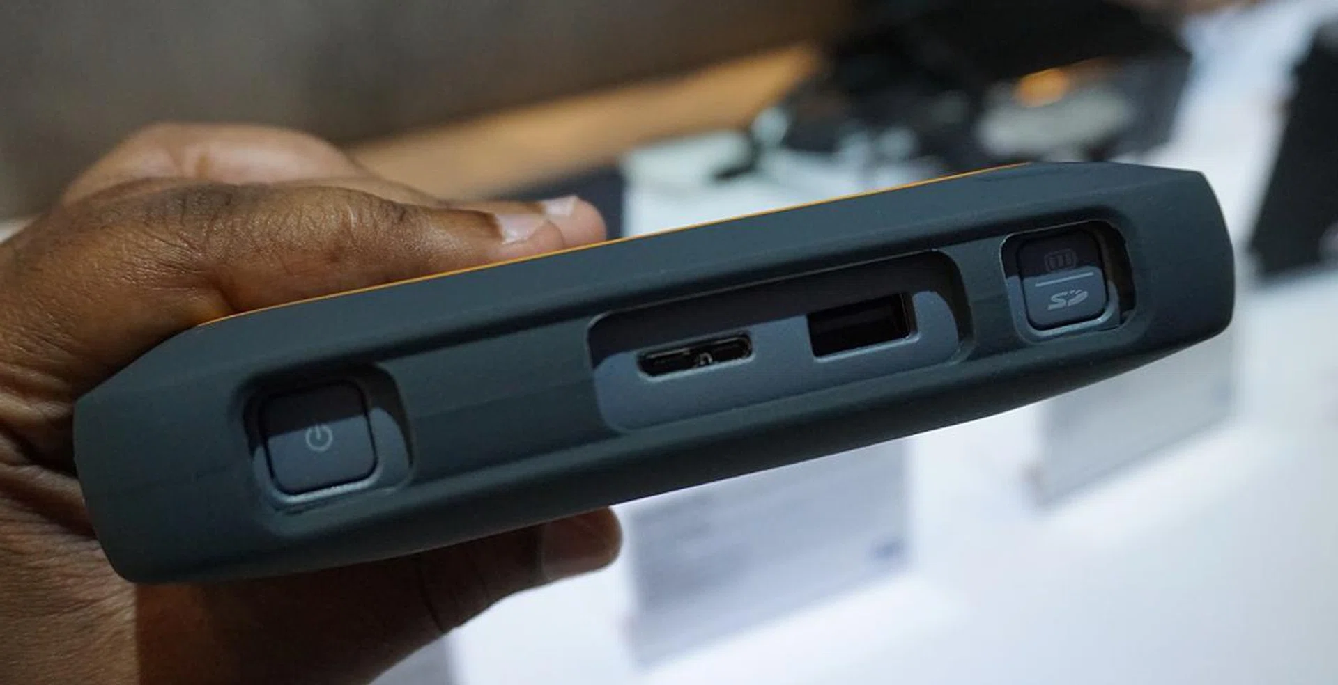 On the top, you'll find a power button, dual USB 3.0 interfaces to power the drive and to interface other devices, as well as a dual-function button to reflect battery status or back up an SD card.