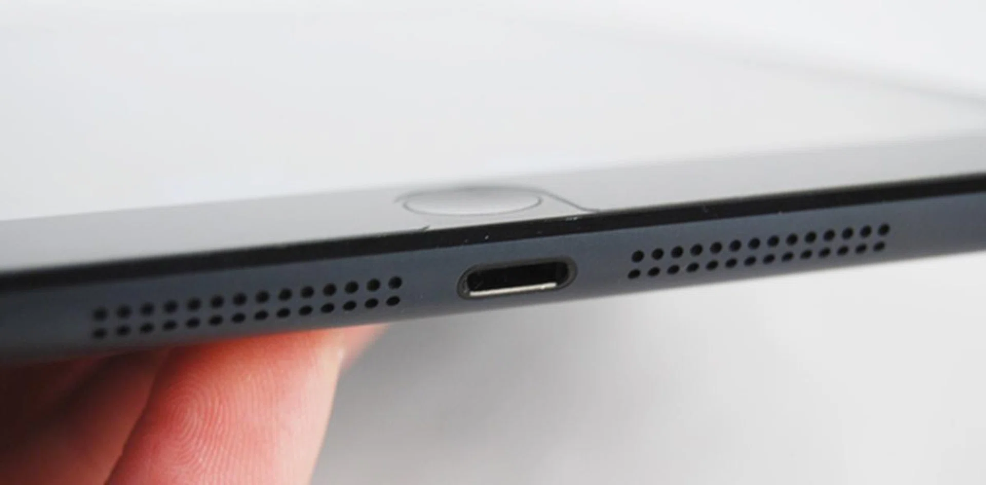 The Apple iPad Mini is equipped with the same Lightning dock connector as the iPhone 5. Flanking its sides are two stereo speakers.