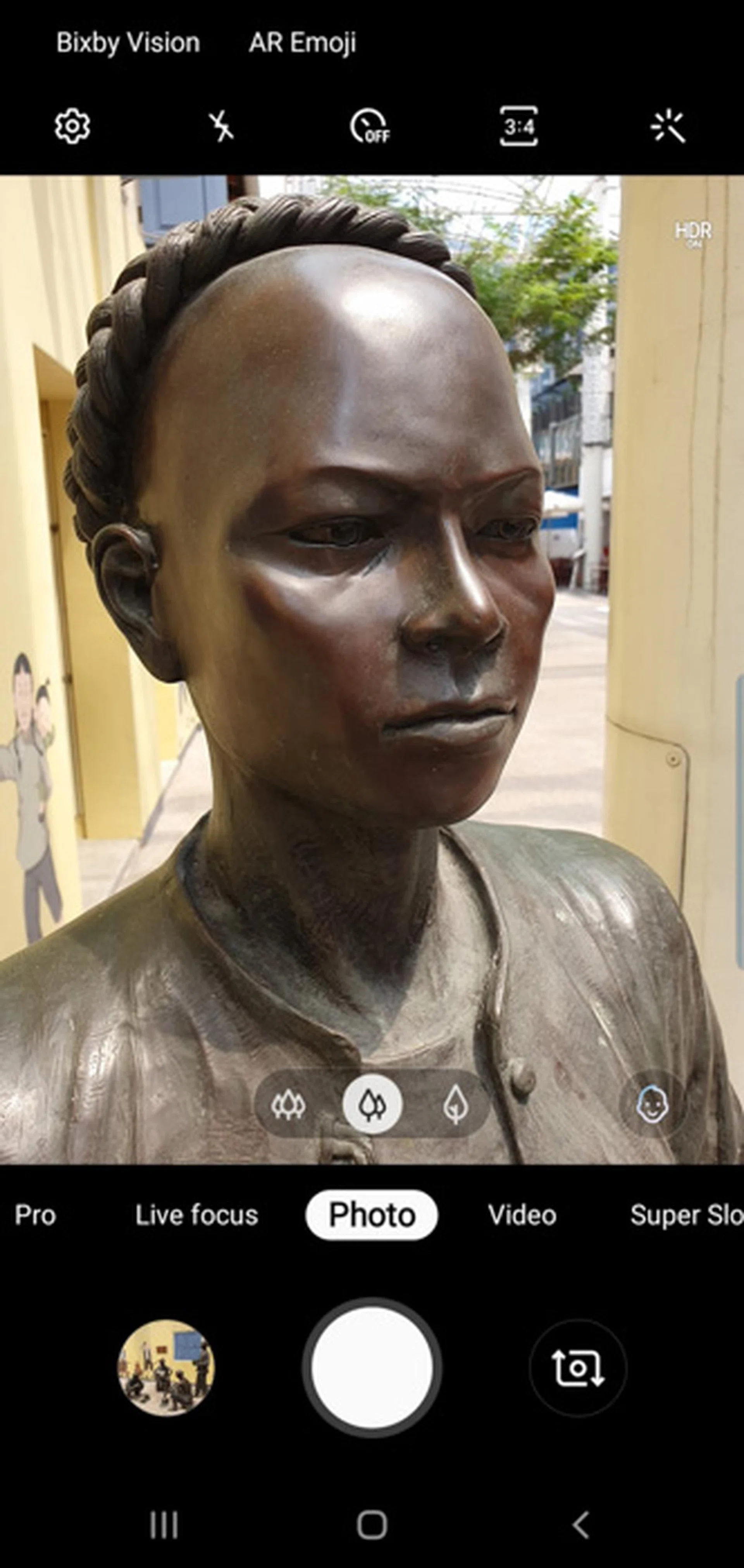 That little face icon indicates the camera has detected a face and has shifted to portrait mode.