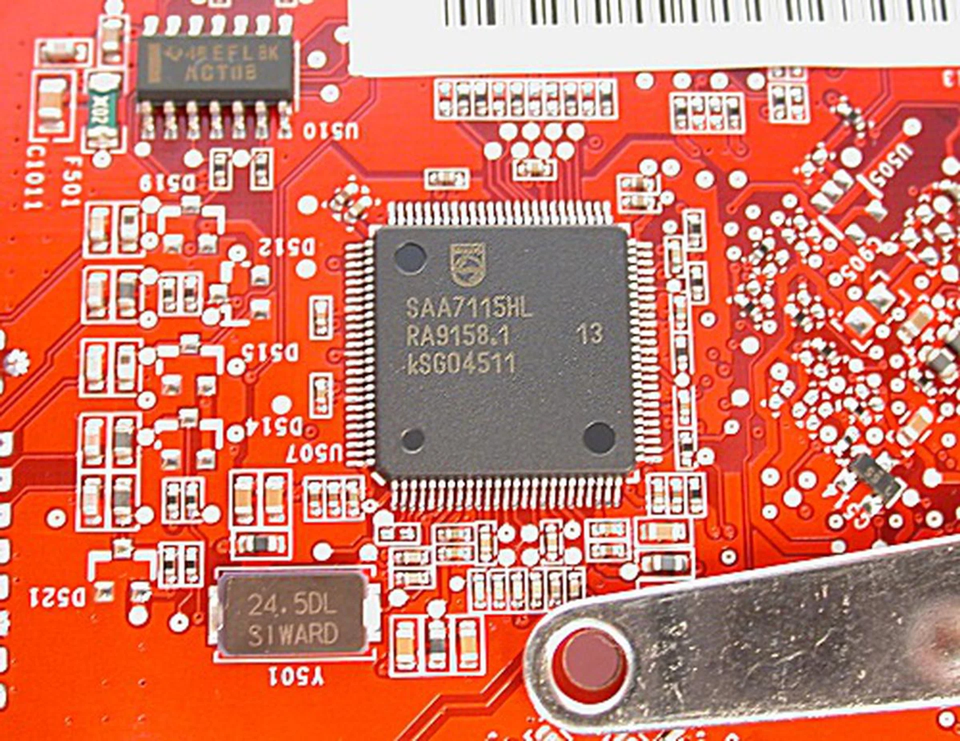 Zooming in, the IC was found to be an SAA7115 video decoder from Philips, which enables the card to perform analog video captures.