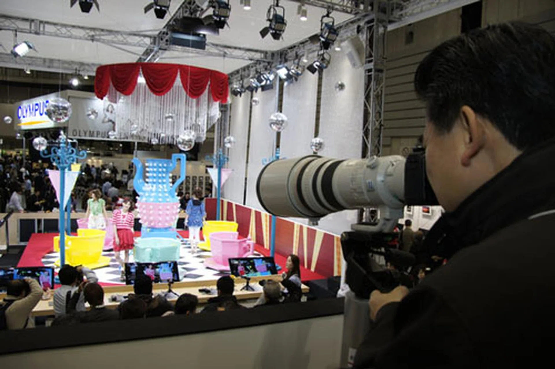 Not to worry, the Canon booth's got you covered with a merry-go-round of models for you to photograph.