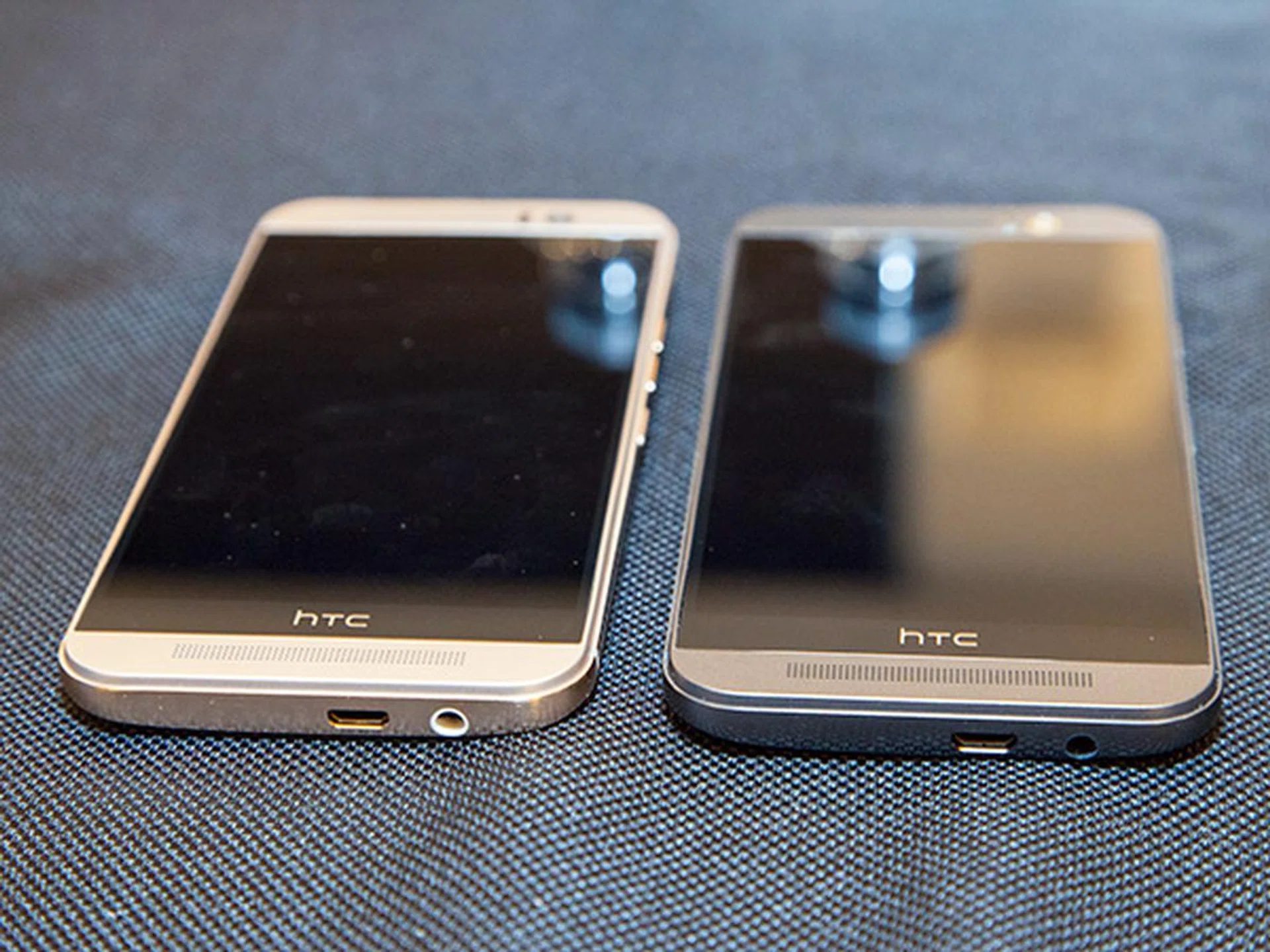 Here's another look at the two-tone gold on silver (left) and gunmetal grey (right) versions of the HTC One M9. Also seen here is the location of the headphone jack and USB connector, both located at the bottom of the phone.