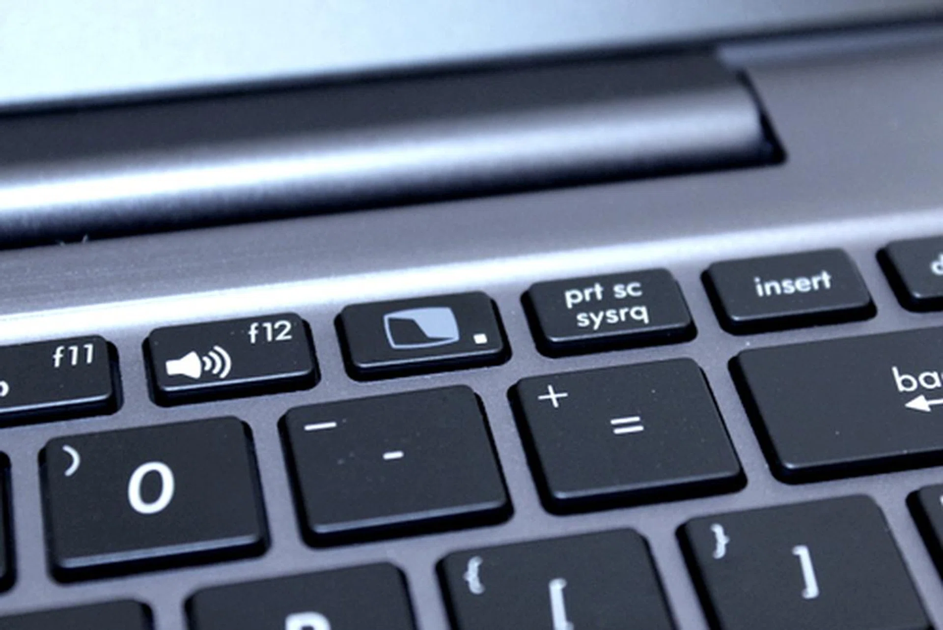The Screen Switch button is found after the F12 button. 