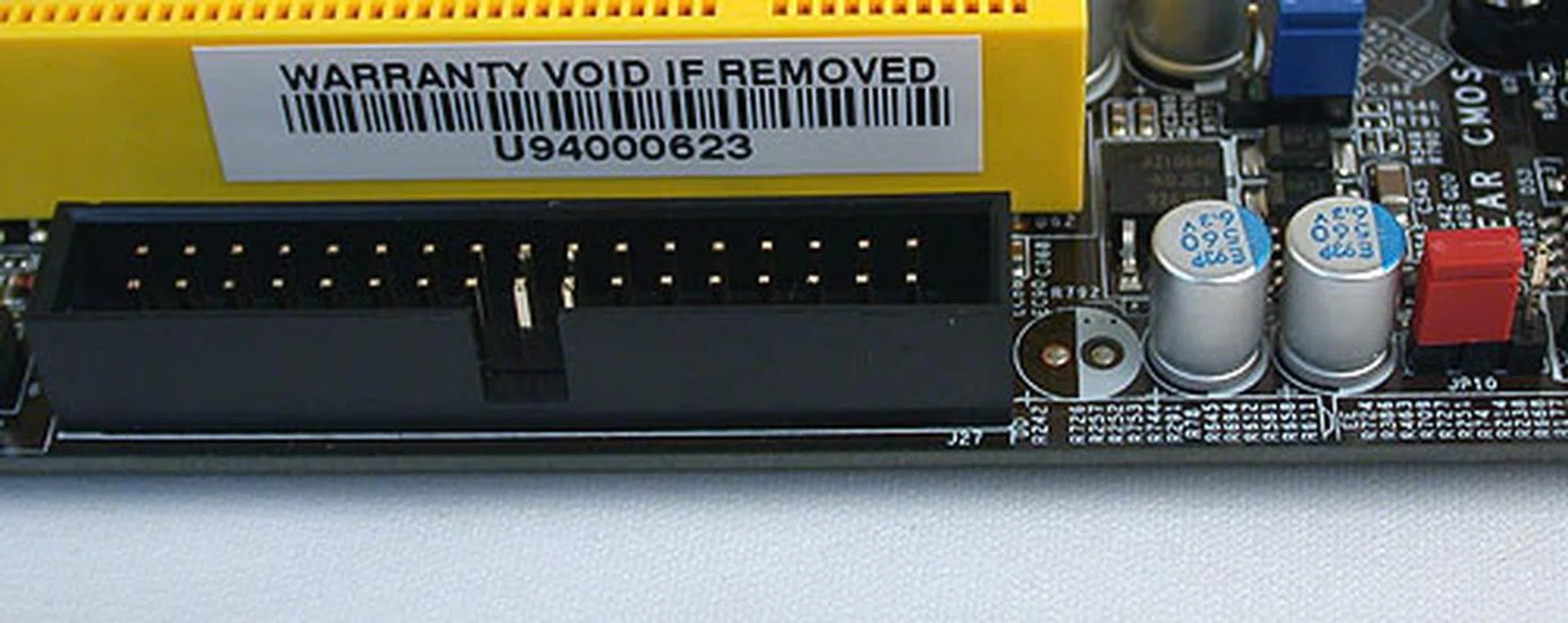 DFI has included a floppy controller with the connector at the very edge of the board. The red jumper seen here is for users to clear the CMOS.