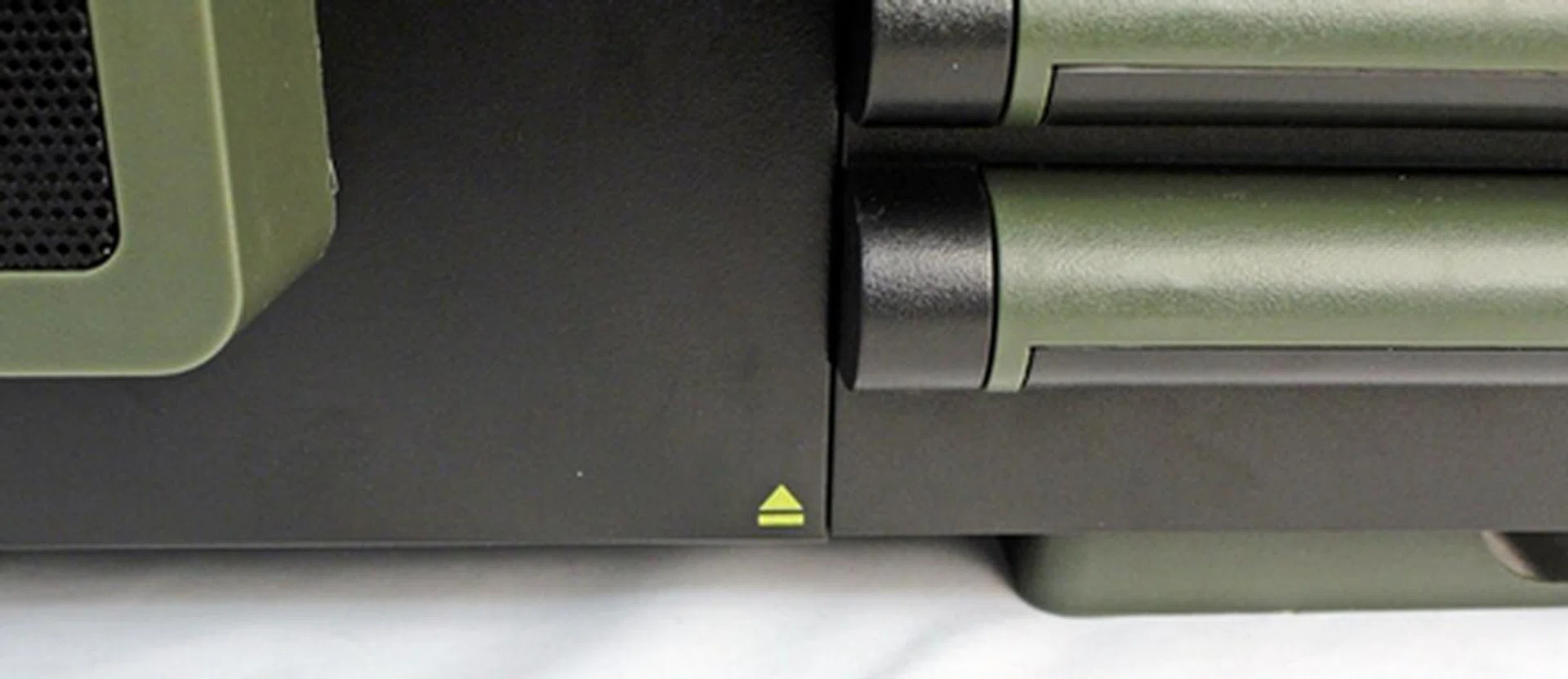 The yellow arrow marks the position of the button at the chassis' bottom, which will allow the side panel to swing open when the button is depressed. We'll take a closer look at the innards in the following pages.