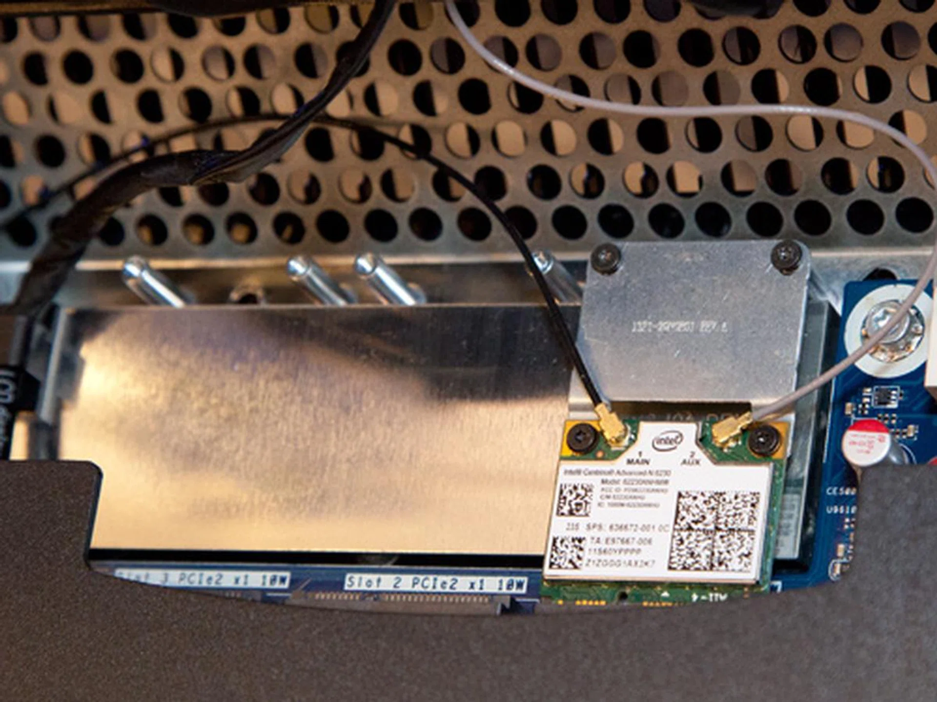 Above the motherboard, you'll find three mini PCIe x1 slots for expansion purposes. You can see one of the slots are already installed with a wireless network card.