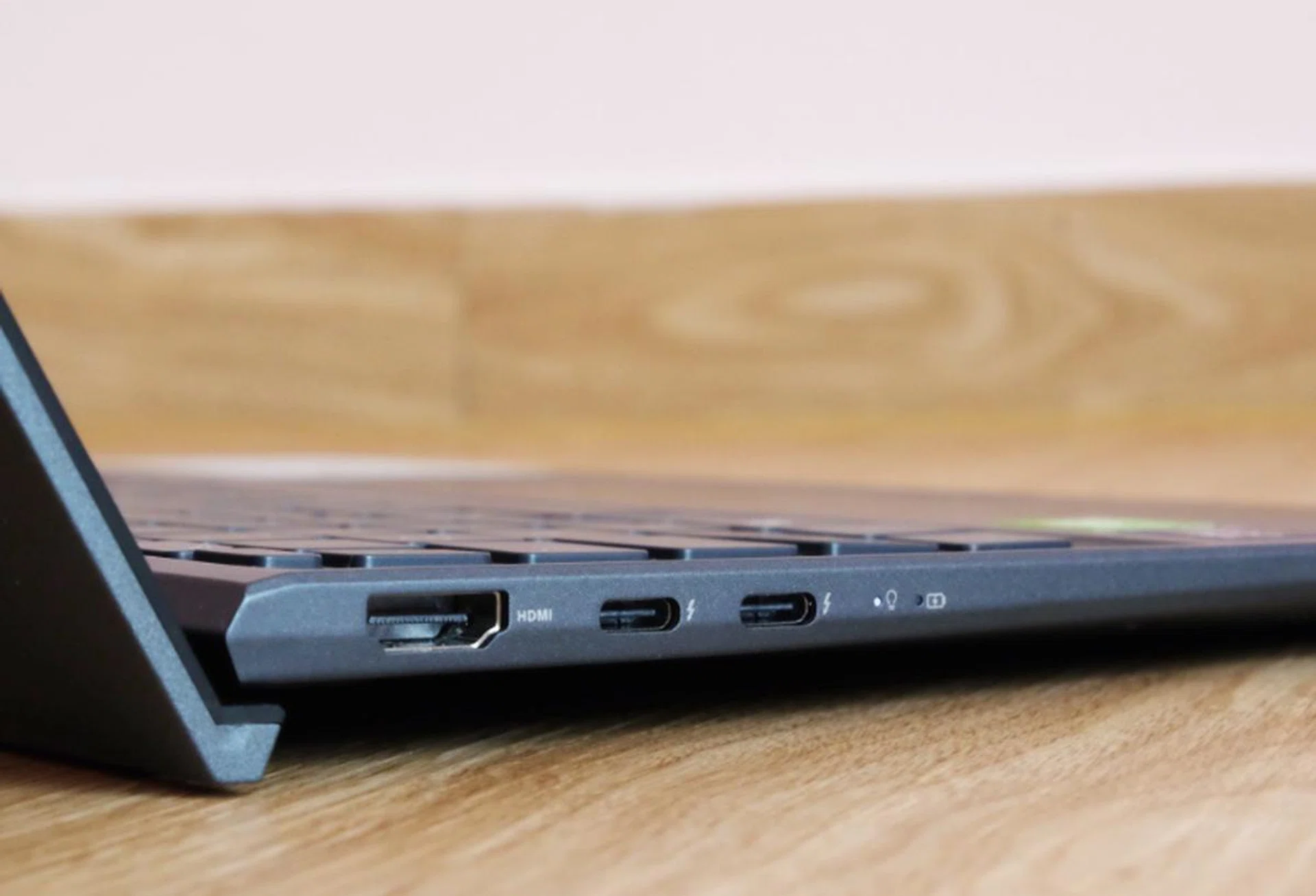 On the left are two USB-C ports that support Thunderbolt 4 and a full-size HDMI 2.0 port. You'll also notice the notebook's ErgoLift in action, which uses the screen's lid to prop up the keyboard for a better typing experience.