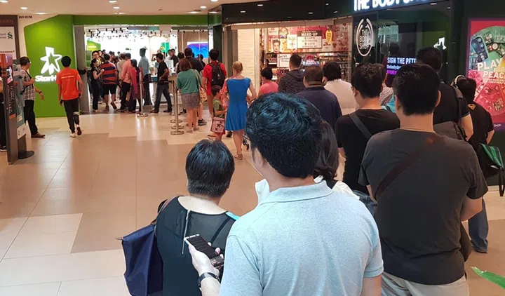 A queue of approximately 40 people for the iPhone X at StarHub's Plaza Singapura outlet. The shop doubles as a collection point.