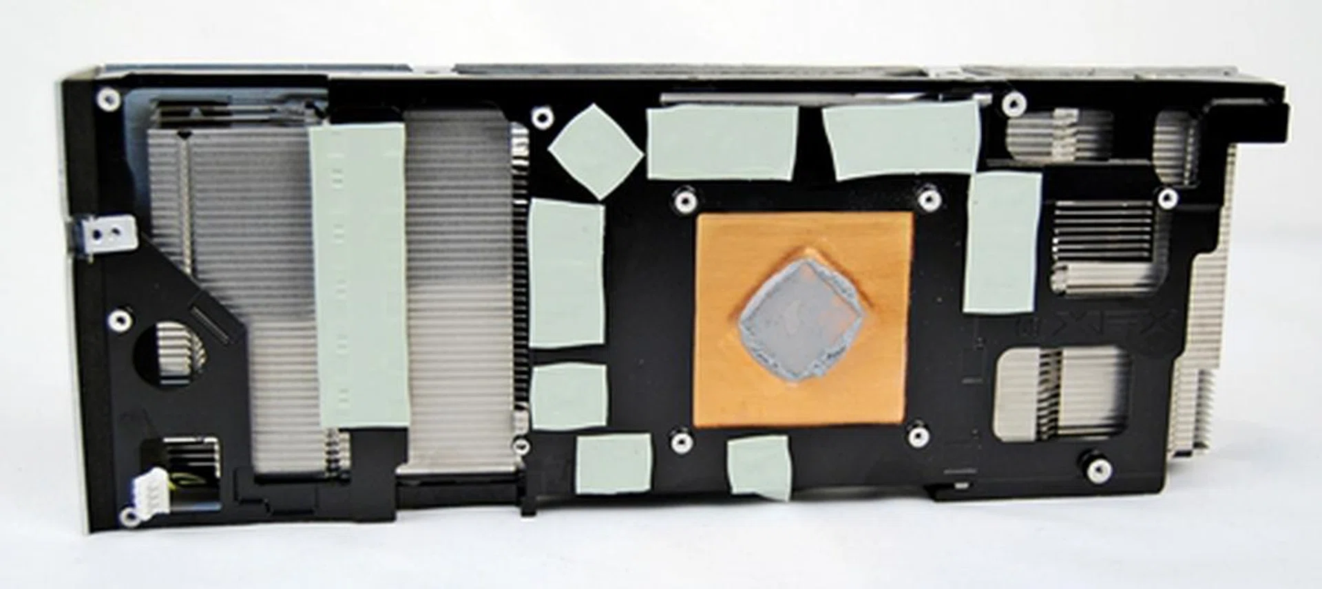 The back of the heatsink that is housed within the twin-fan casing. In order to remove the heatsink from the fan housing, we had to remove a total of 19 screws! This task would entail a lot of elbow grease, but only if you intend to do some modifications of your own. Besides cooling the AMD Radeon HD 7950 GPU, there are a number of thermal pads that play an important part to cool the memory chips and MOSFETs on the PCB of the graphics card.