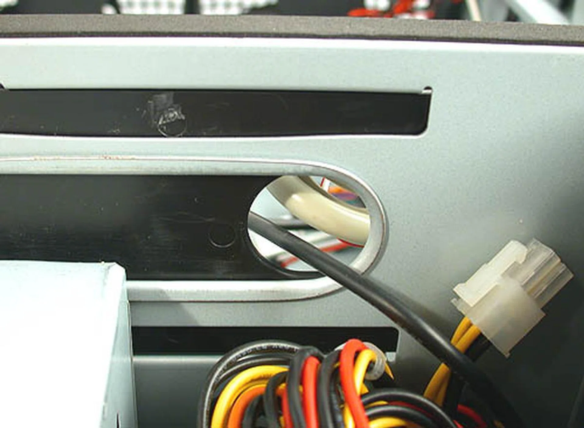 Due to its thermal isolation concept, all cables and wires have to go through such bottlenecks to travel between the different compartments. It can be troublesome if you have multiple power cables or thick IDE cables running through them. The good news is you probably only have to do it once and thermal isolation is a rather good idea for HTPC casings.