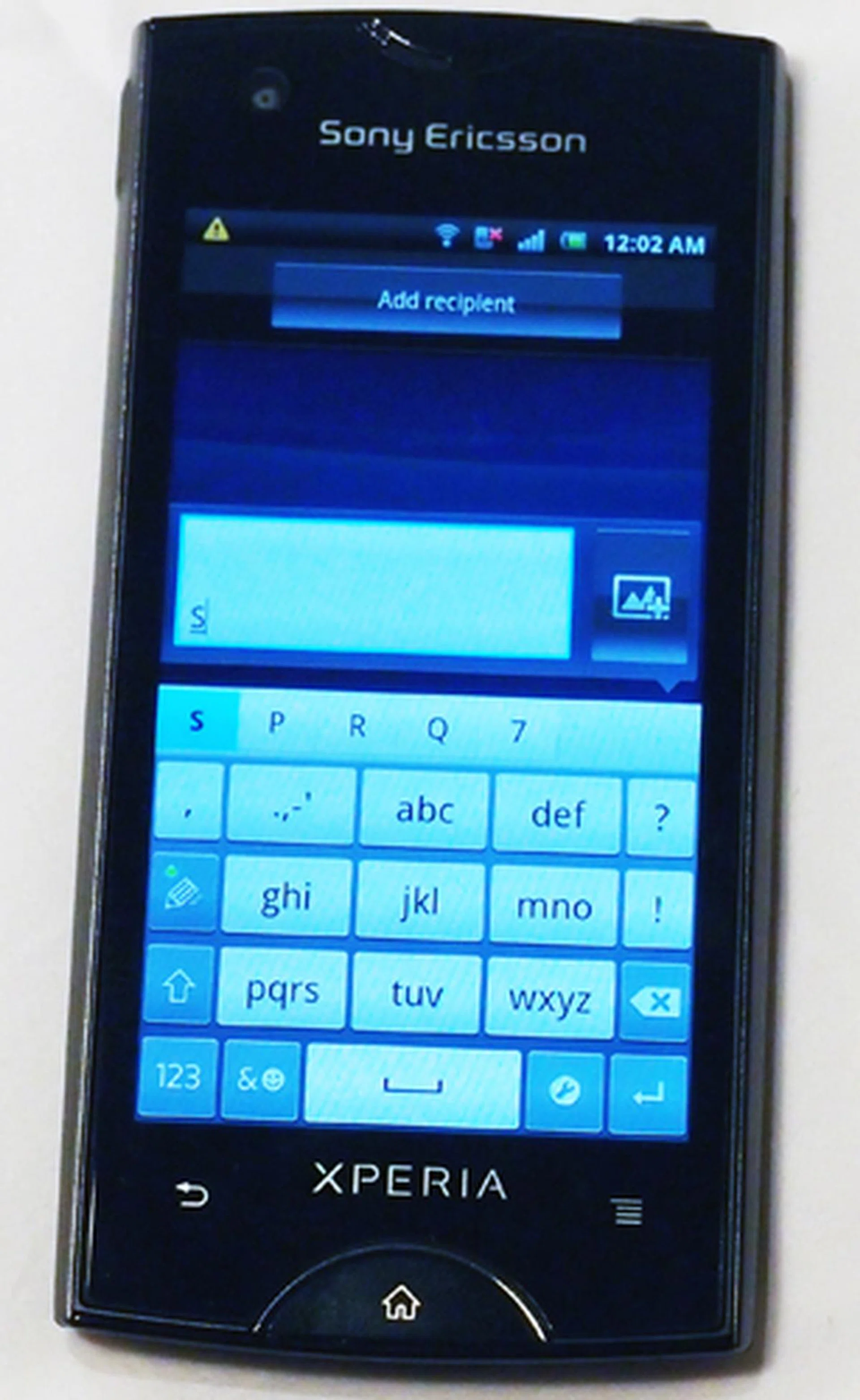 On entering a text input box, the phone starts off with an old-school alpha-numeric keypad in portrait mode...