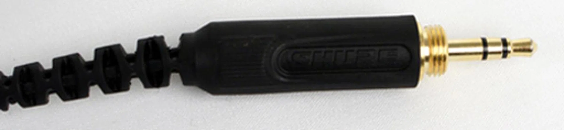 The 3.5mm gold input jack. The threaded head allows for screw-on attachments which can change the input plug you can use with the SRH550DJ. Currently there is a an attachment to convert it to a quarter-inch plug.