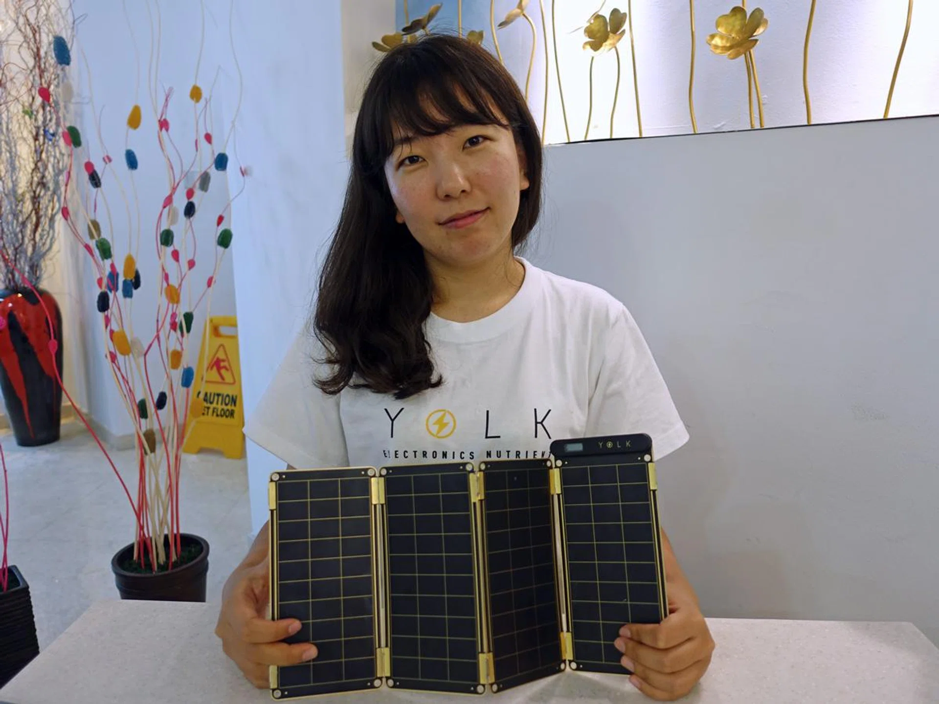 Sungun Chang, designer and CEO of her startup, Yolk, with the Solar Paper.