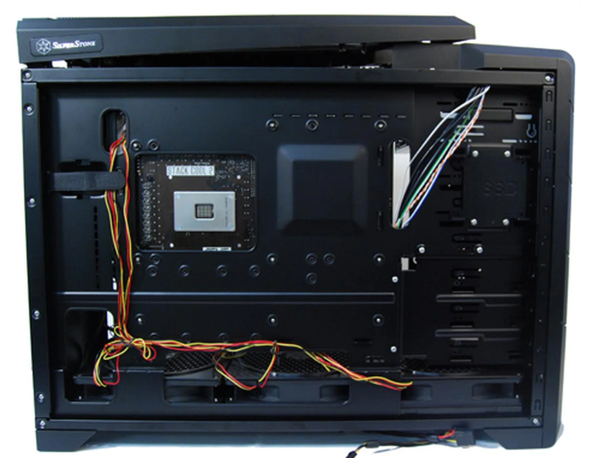The reverse side of the motherboard tray has an opening for easy swapping of CPU cooler. Note also the SSD tray to the right.