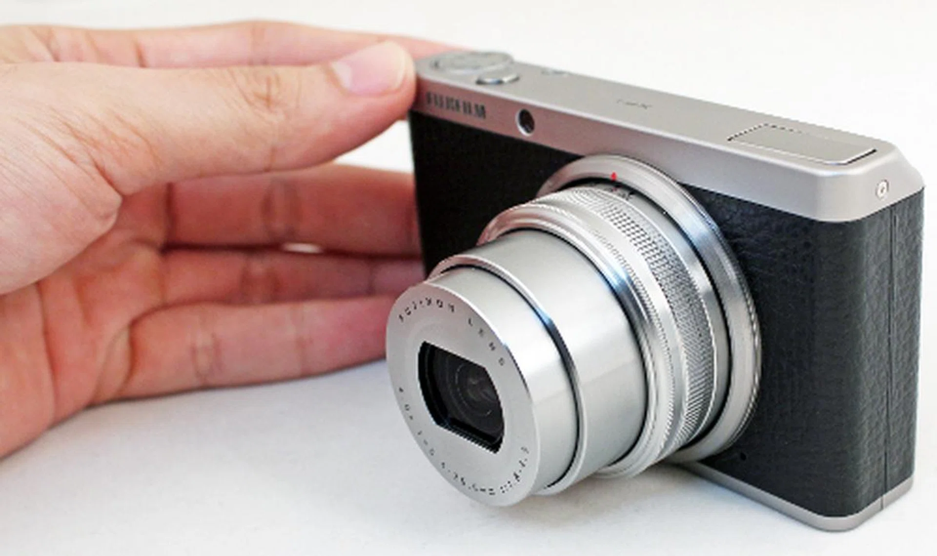 With an extending lens barrel and a rotating zoom ring, the XF1 requires both hands on the camera to shoot.  
