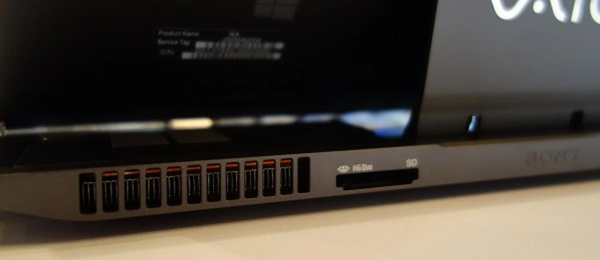 The memory card slot is positioned at the rear, right next to the air vent.