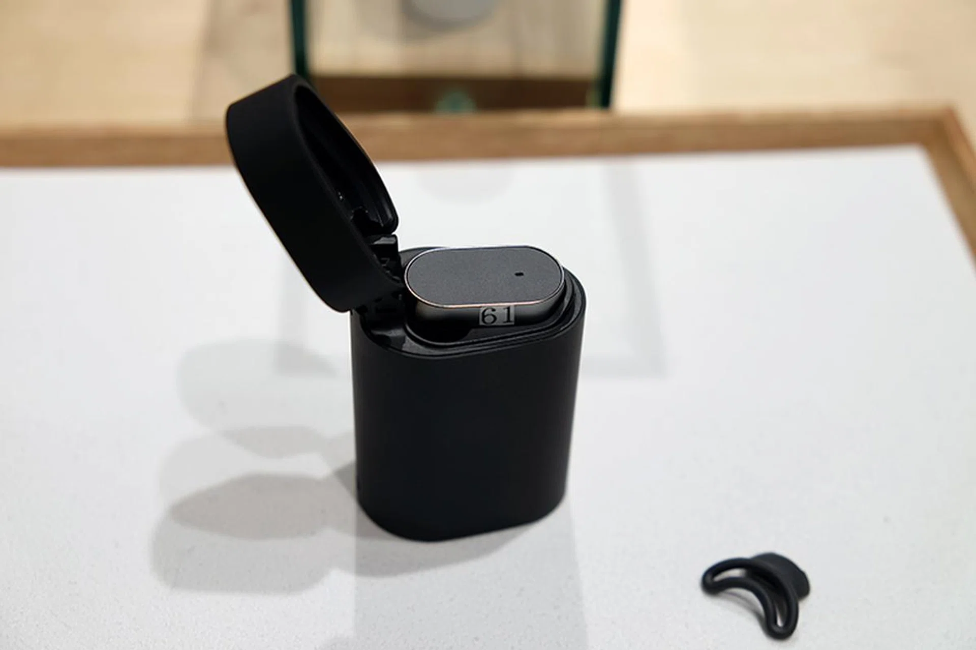 The Xperia Ear is nested in it's carrying case, which doubles as a portable charger for the smart earbud.