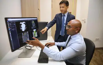 Assistant Professor Lohendran Baskaran (right), senior consultant with National Heart Centre Singapore’s cardiology department, and Associate Professor Zhong Liang, co-director and core technical lead of CVS.Al research laboratory, viewing heart scans. Photo: The Straits Times