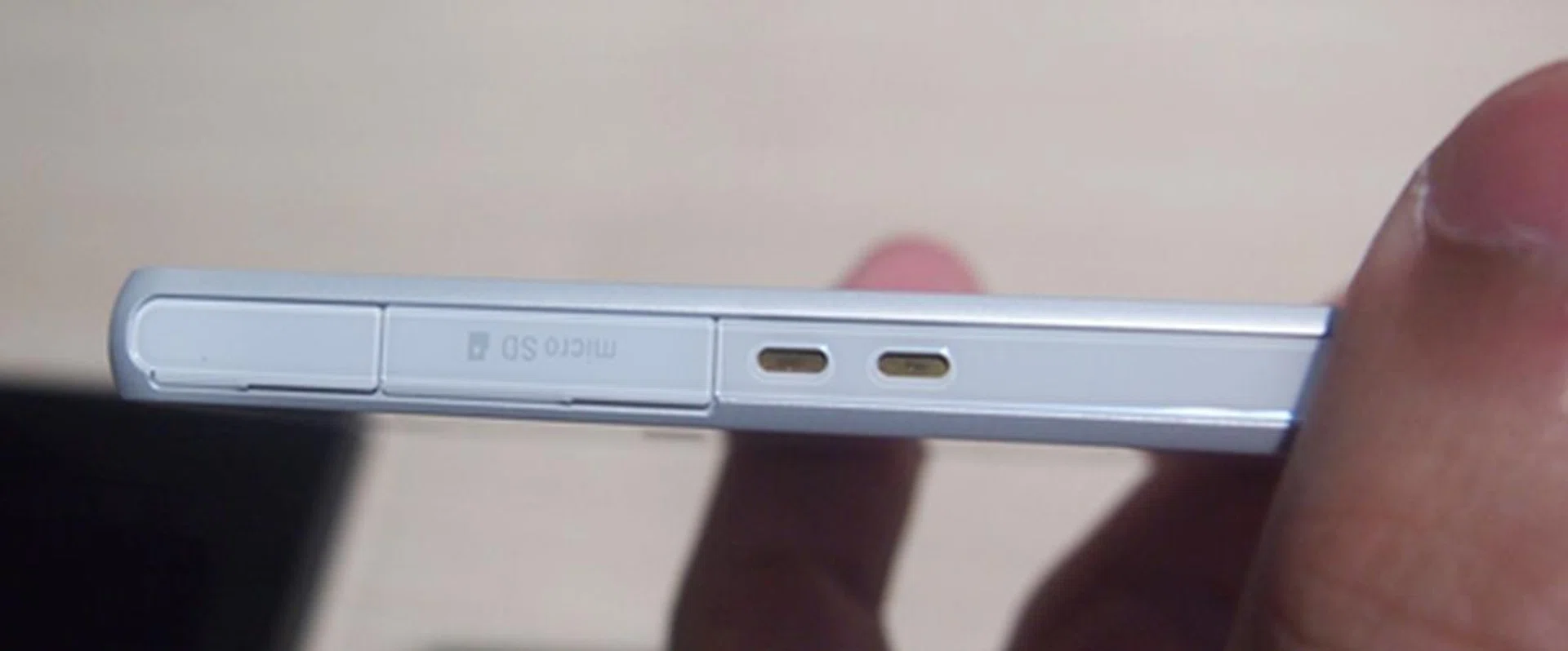 The microSD card slot is covered with a tight plastic cover, which is both good and bad depending on your perspective. Having a tight cover ensures no dust or water can seep in, but it will be a hassle if you need to remove the memory card often. To the right of the card slot is two dock connectors, which enables the Xperia Z to fit into its docking accessory.