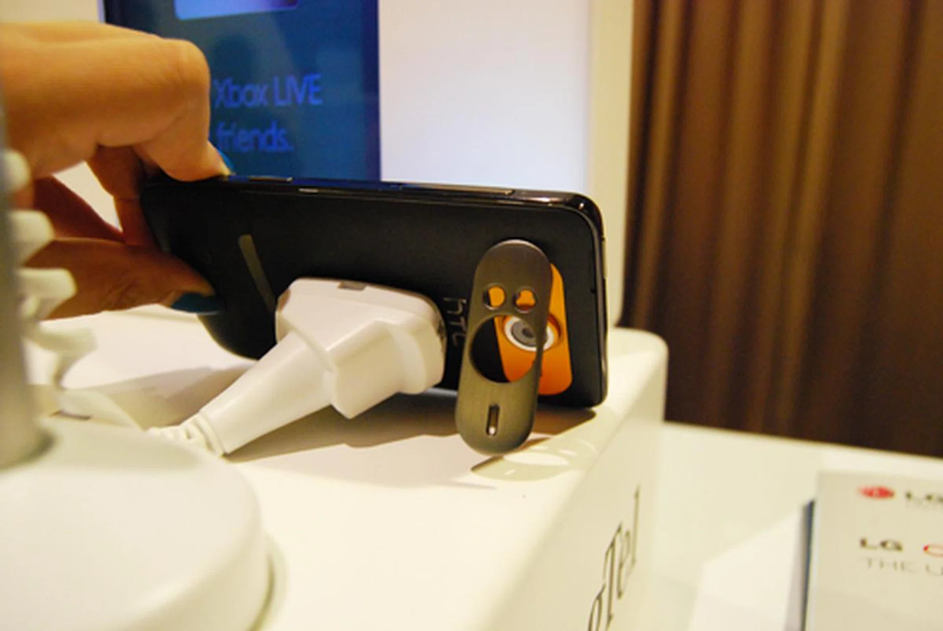 An integrated kickstand (surrounding the 5-megapixel camera and dual-LED flash) at the rear to prop the HD7 at an appropriate viewing angle highlights its positioning as a multimedia device.