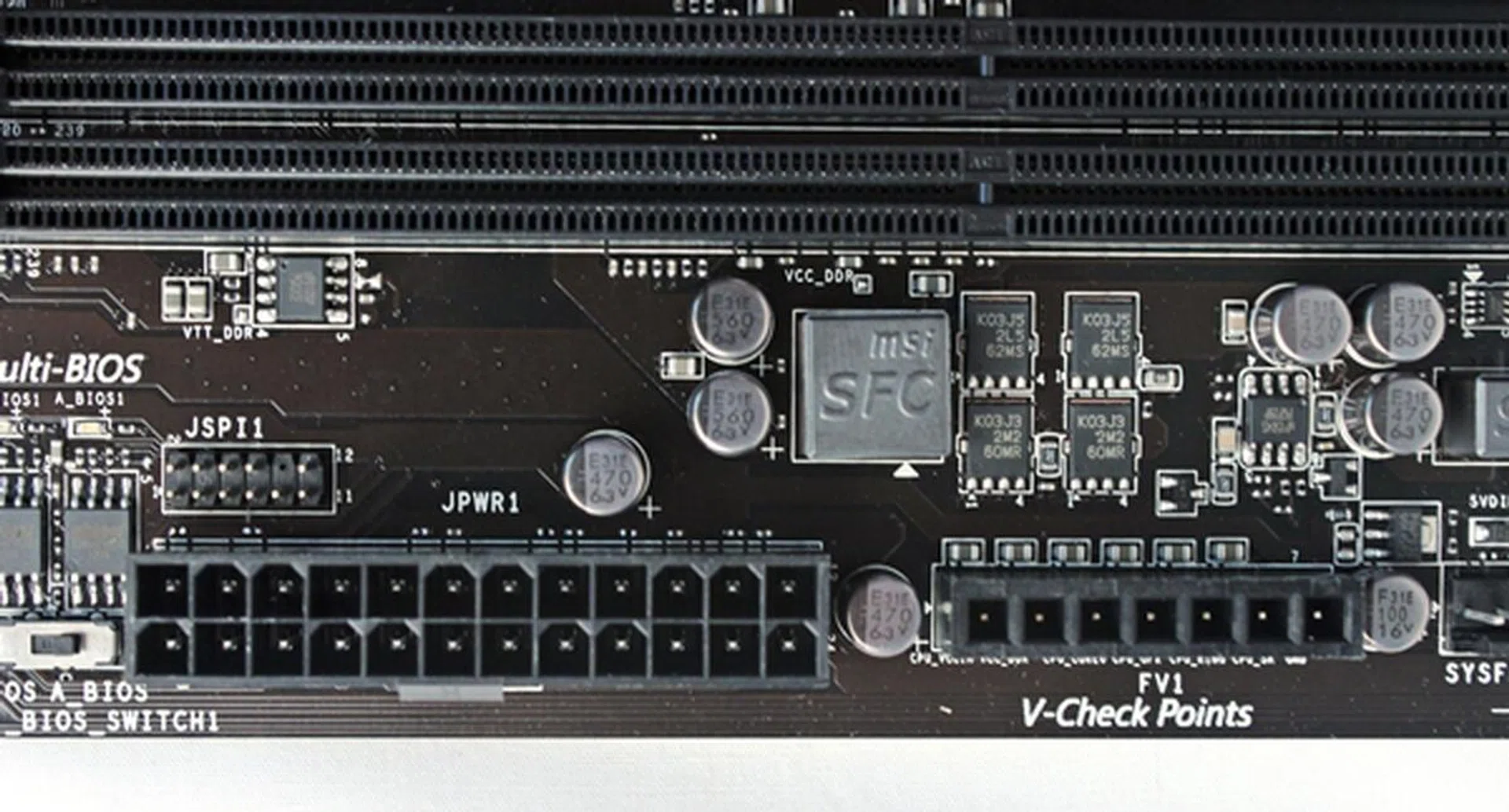 The ATX power connector and the V-Check connectors are located to the right of the Multi-BIOS switch. They would usually share PCB space with the Easy Button 3 that have been relocated to the left edge of this board, thus leaving this area clutter free.