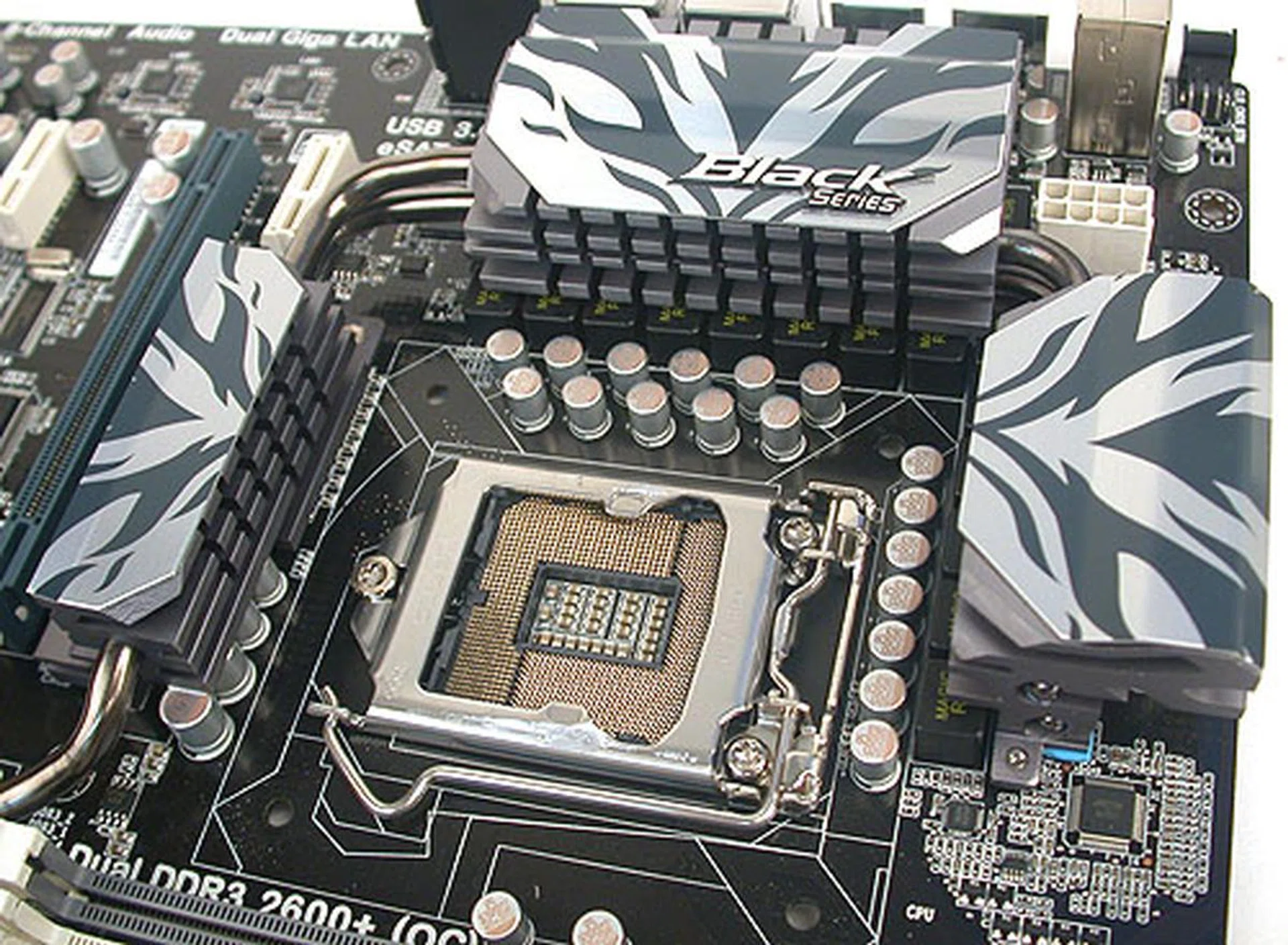 The CPU socket is surrounded by moderately high heatsinks, linked by heatpipes. We didn't find them intrusive when installing or removing the CPU heatsink. 