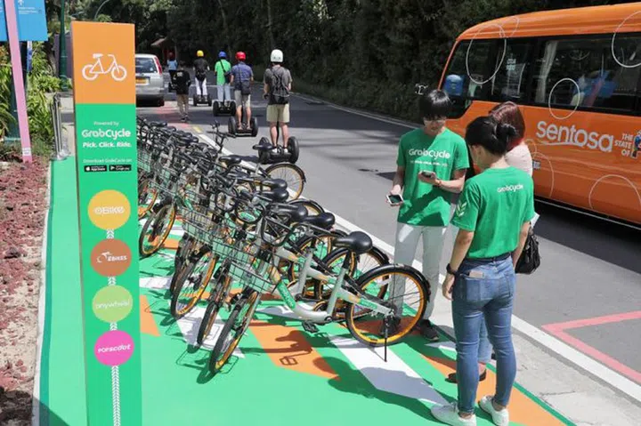 GrabCycle's app will unite bike-sharing services oBike, GBikes and Anywheel and e-scooter sharing operator Popscoot on one platform. Sentosa is a venue partner, so users of the partner services can park at GrabCycle parking stations there. (BT Photo: Kelvin Chng.)