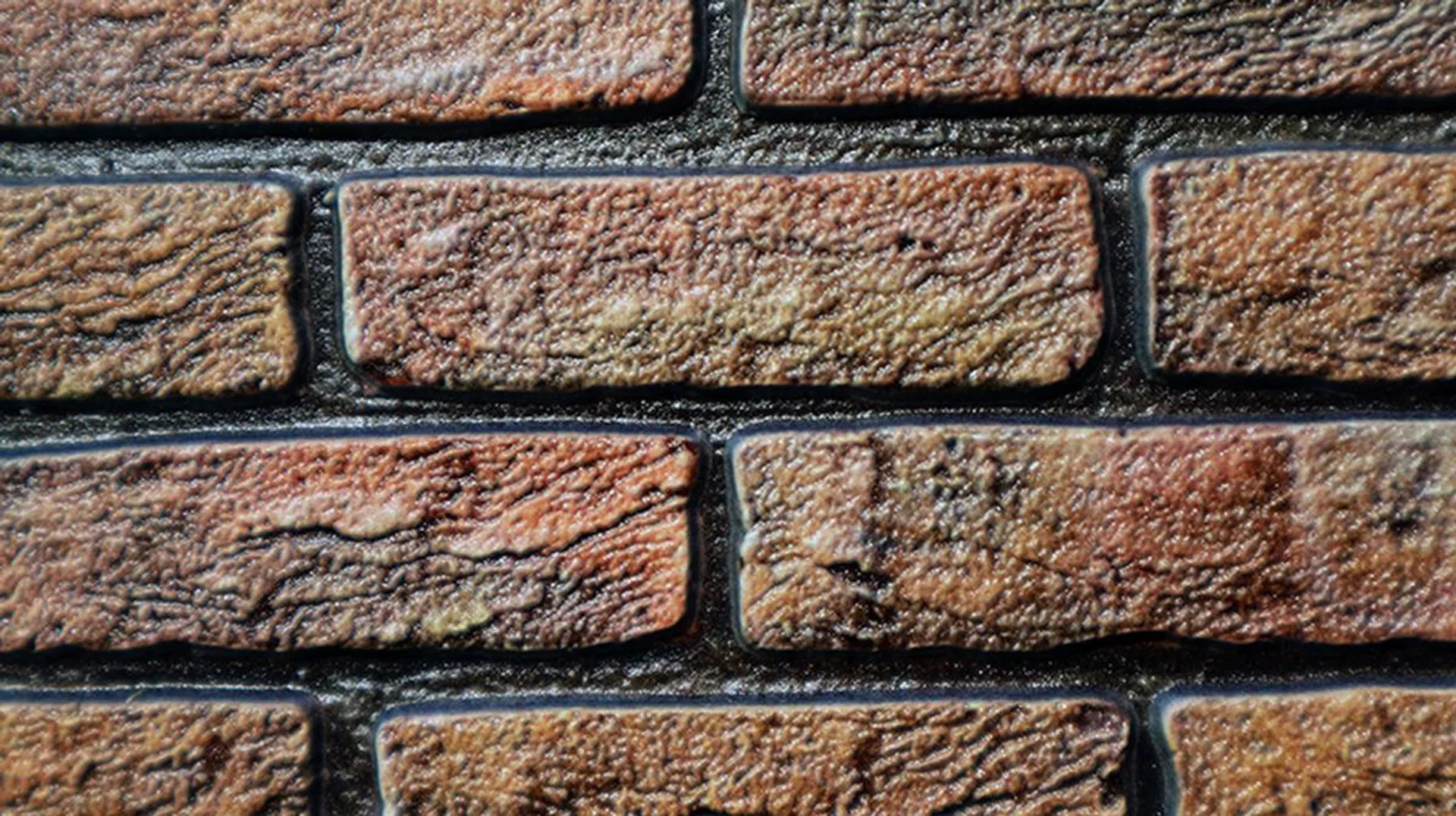 This is not an actual brick wall - this is a print by Canon, and it captures the textures and gloss as printable data before it goes out as a copy.