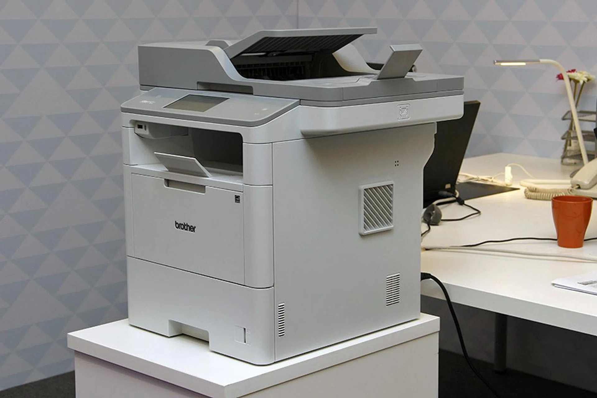 The MFC-L6900DW prints up to 50ppm, is wireless and network enabled, and has a 4.85-inch touchscreen, a dual-CIS ADF, and an NFC card reader.