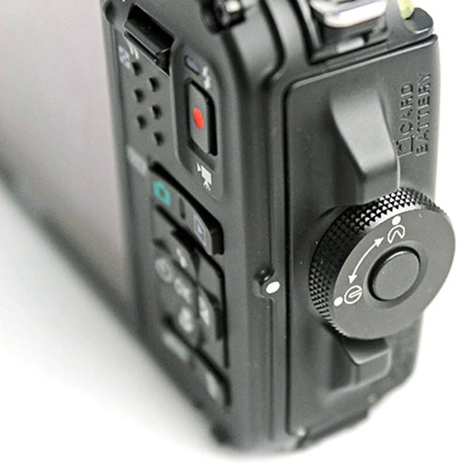 To access the battery and memory card slot, you have to press the button in the middle of the lock and rotate the dial.