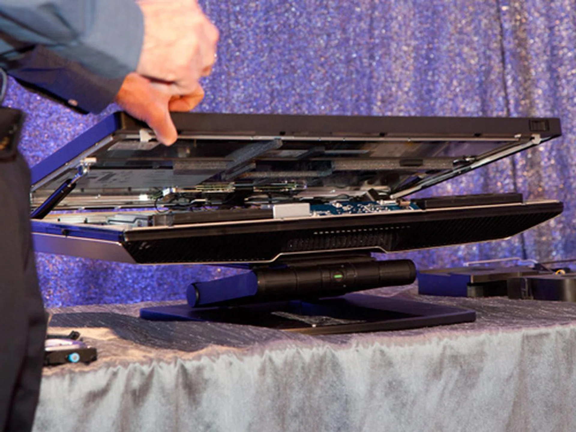 By pressing the two latches located in the two corners below the screen, you can easily pop open the chassis. You don't need a screwdriver or any fancy Torx driver or powerful suction cups to do this. It's easier to open this than a tin of biscuits.