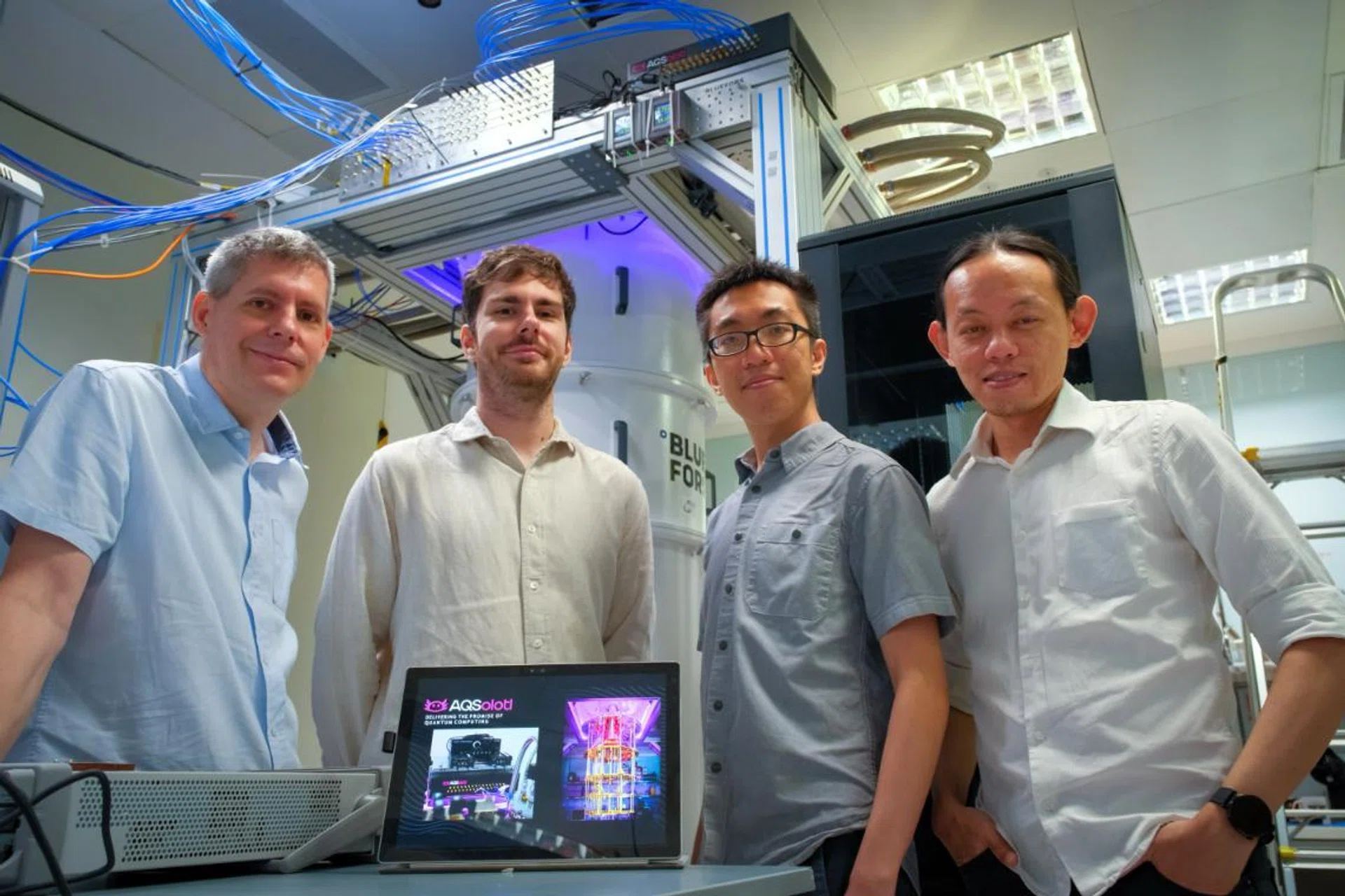 (left to right) NTU Assoc Prof Rainer Dumke with his other co-founders of AQSolotl, Chief Executive Officer Mr Patrick Bore; Head of Quantum Algorithms Mr Paul Tan; and Chief Technical Officer Dr Yap Yung Szen, who is also a Senior Lecturer at the Universiti Teknologi Malaysia. The start-up’s flagship product, Chronos-Q, can be seen at the top right corner of the quantum computer at NTU. Photo: NTU. 