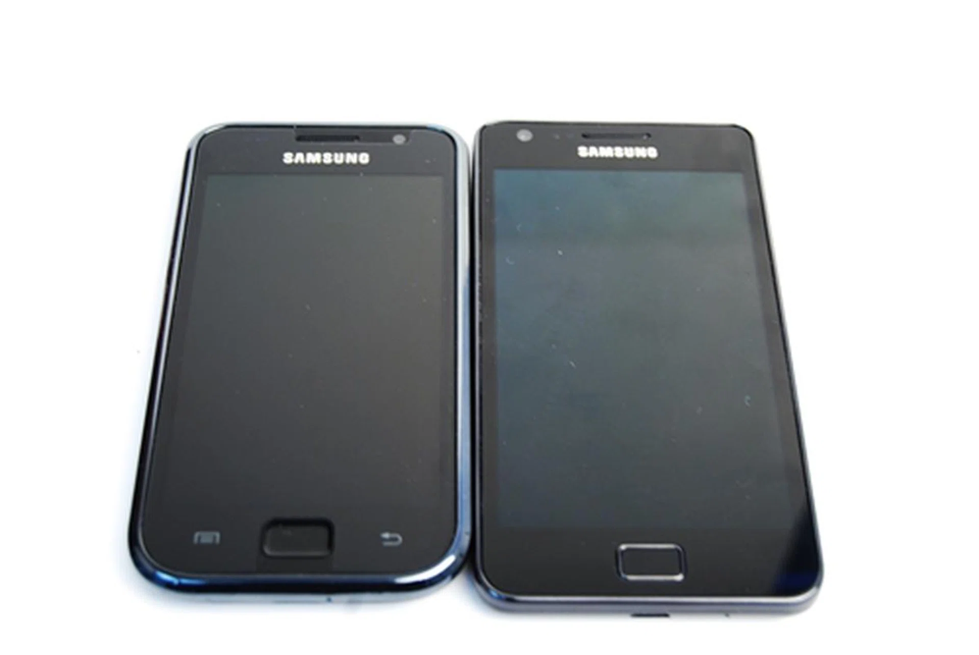 Samsung Galaxy S (left) and Samsung Galaxy S II (right). Notice the absence of the chrome bezel on the latter. On the Galaxy S II, the Menu and Back touch buttons lit up once the screen was activated.