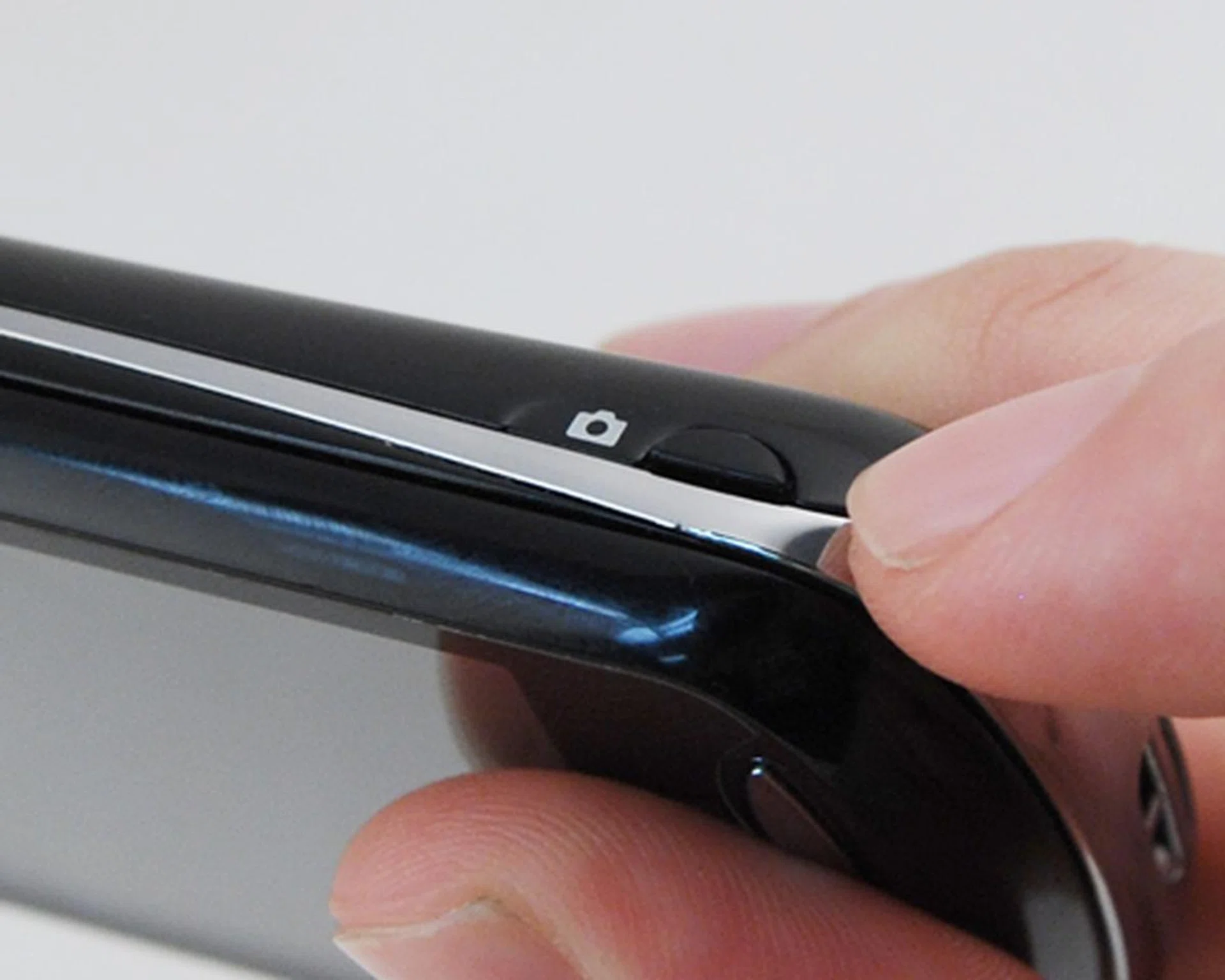 The camera button is so low on the side, you’ll be better off not using it.