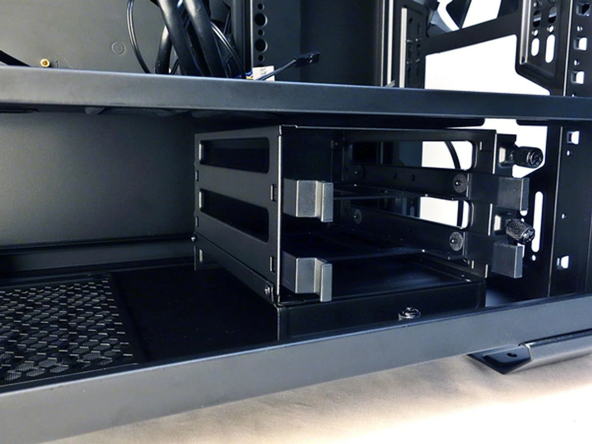 It's recommended to slide the 3.5-inch drive cage onto the mounting tray and secure the cage from within the chassis.